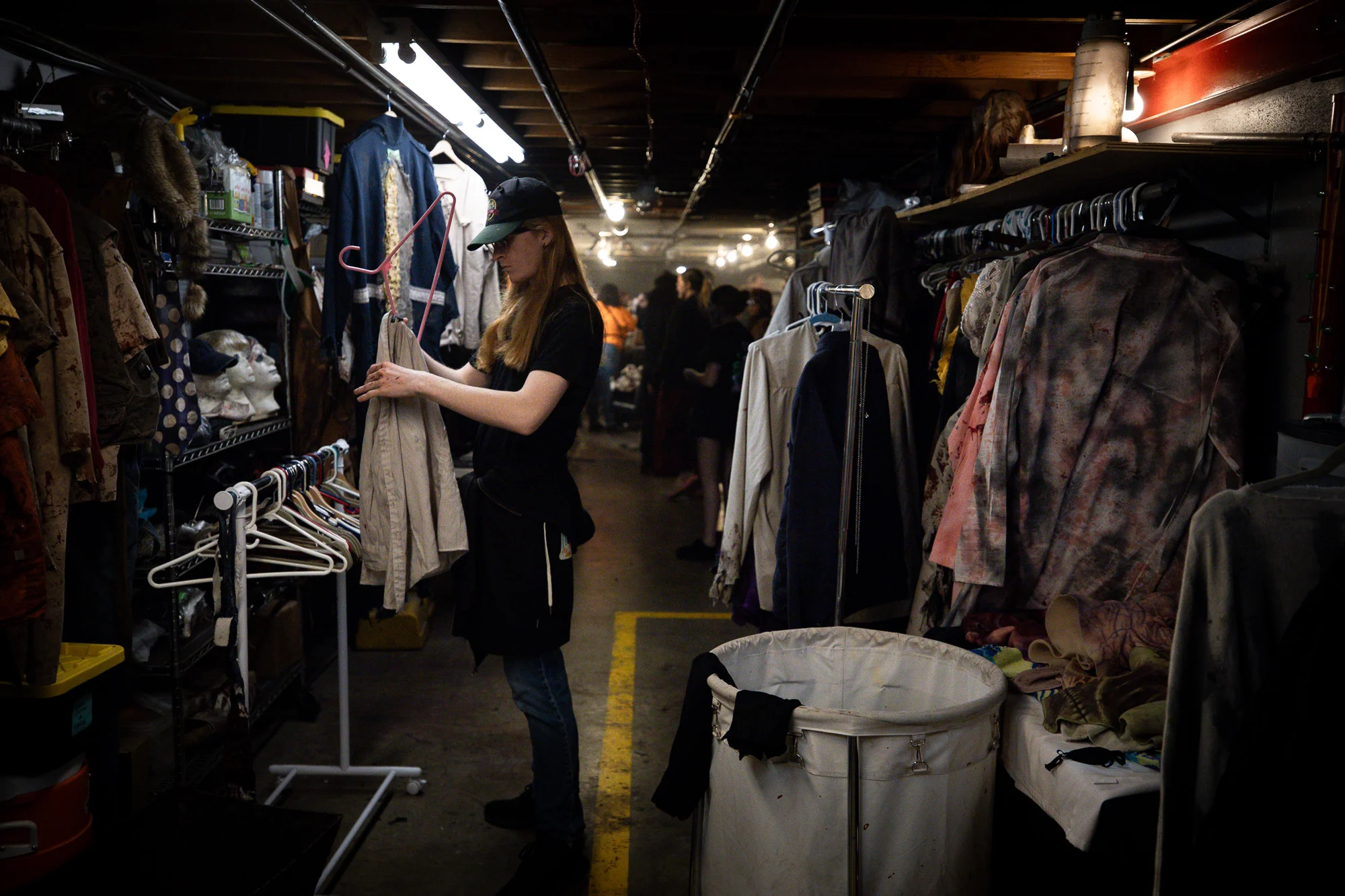 Wardrobe assistant Jonathan Brooks hangs costumes at the 13th Floor. Photo: Cormac McCrimmon, Rocky Mountain PBS. 
