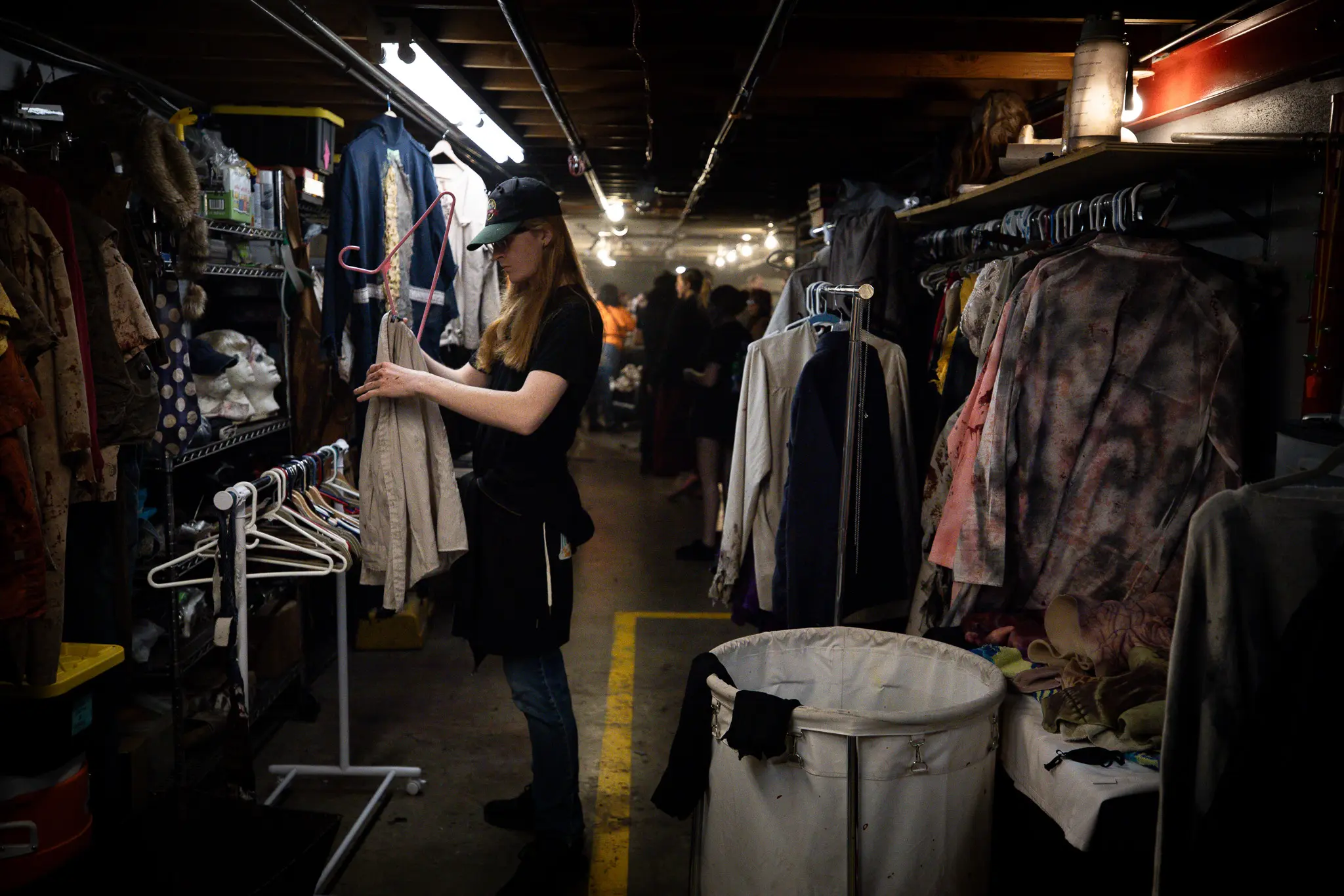 Wardrobe assistant Jonathan Brooks hangs costumes at the 13th Floor. Photo: Cormac McCrimmon, Rocky Mountain PBS. 
