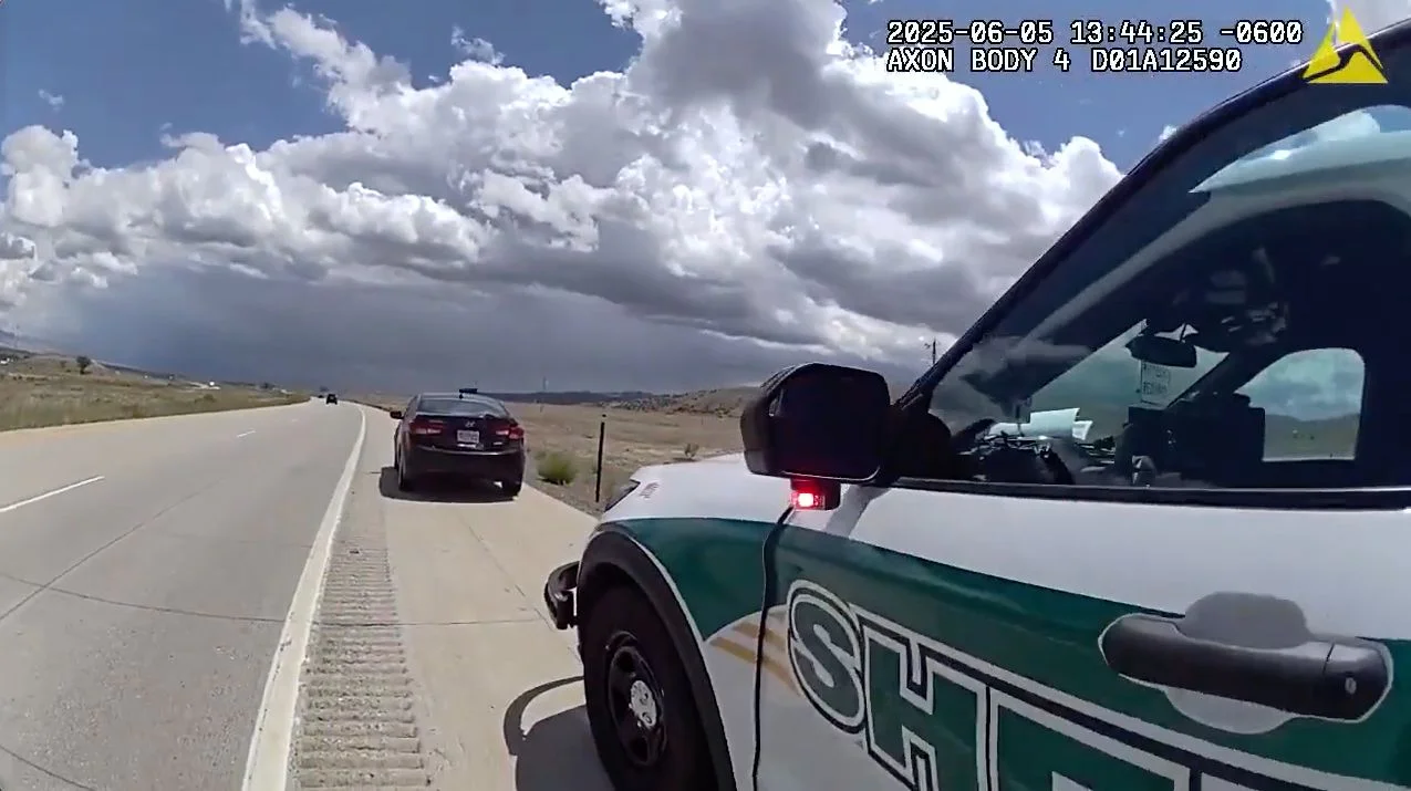 A Mesa County Sheriff’s office car behind Dias Goncalves’s sedan on Interstate 70 on June 5. Photo via body cam video released by the sheriff’s office.
