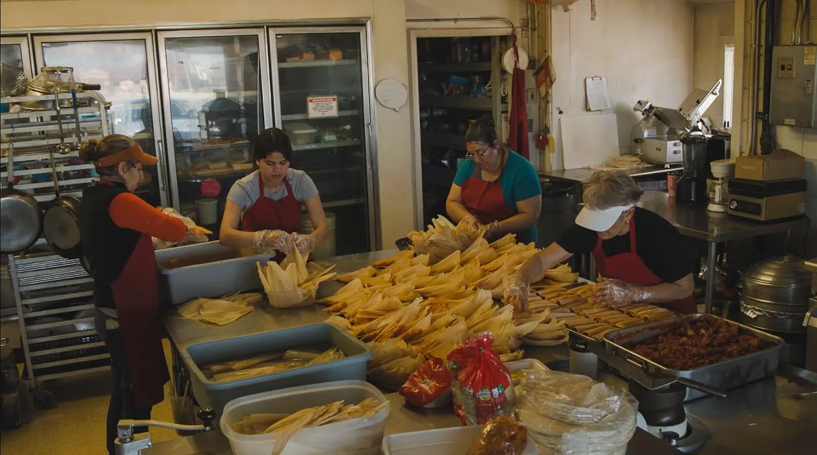 Workers making tamales in the kitchen. Photo: Ziyi Xu, Rocky Mountain PBS