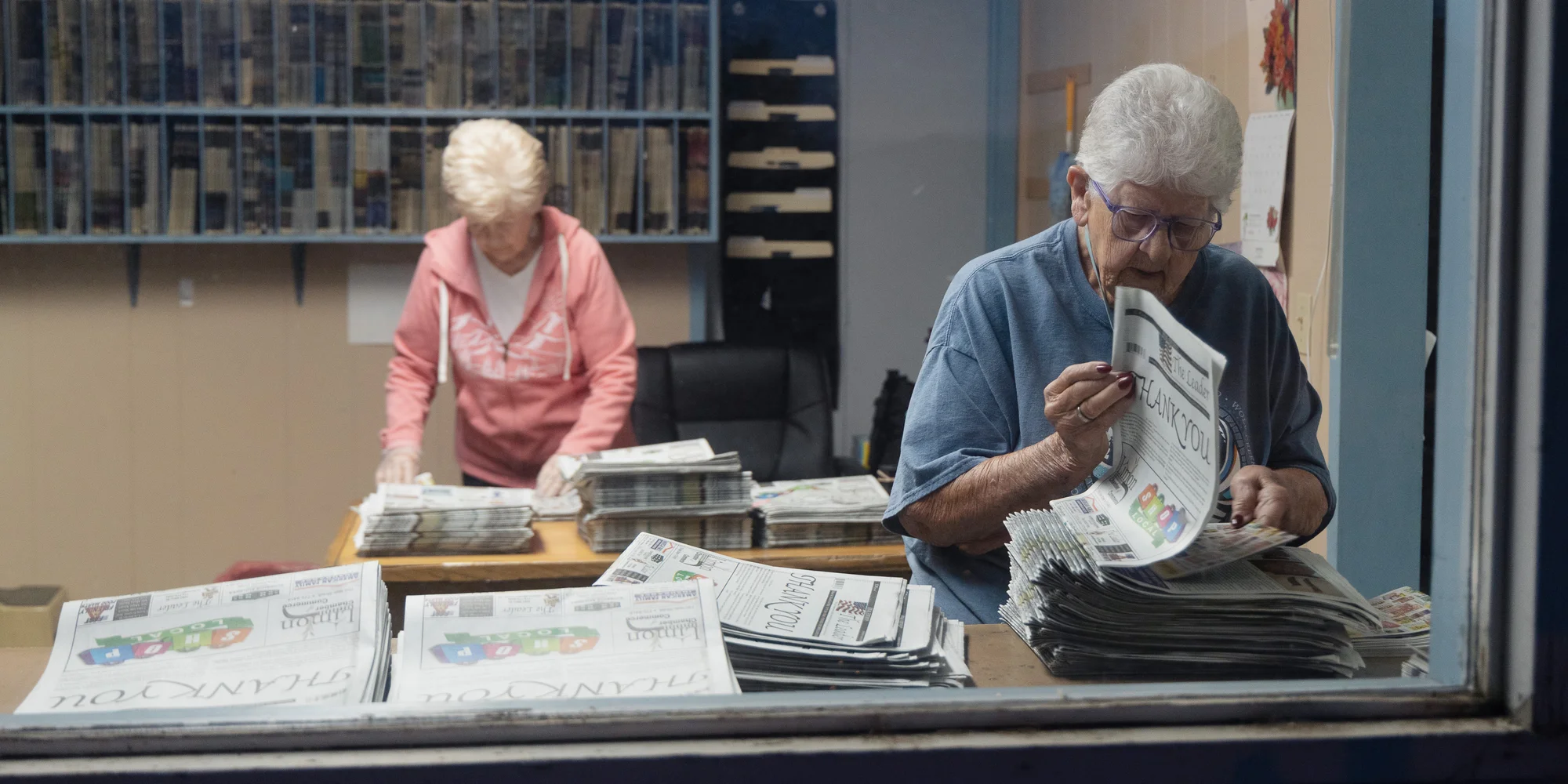 The Leader’s skeleton crew adds inserts and mailing labels to 800 copies of “The Leader.” Most copies reach subscribers via the US Postal Service. Some subscribers live as far as Nebraska, Arizona and Oregon. Photos: Cormac McCrimmon, Rocky Mountain PBS