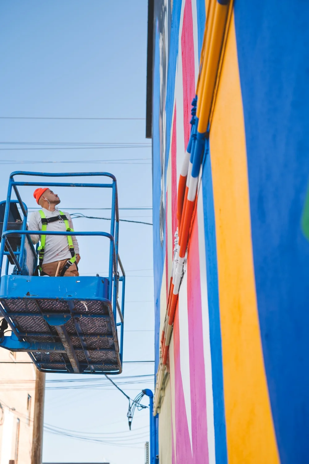 Armando Silva puts the final touches on his WonderWall mural in downtown Greeley. Photo courtesy Gii Astorga