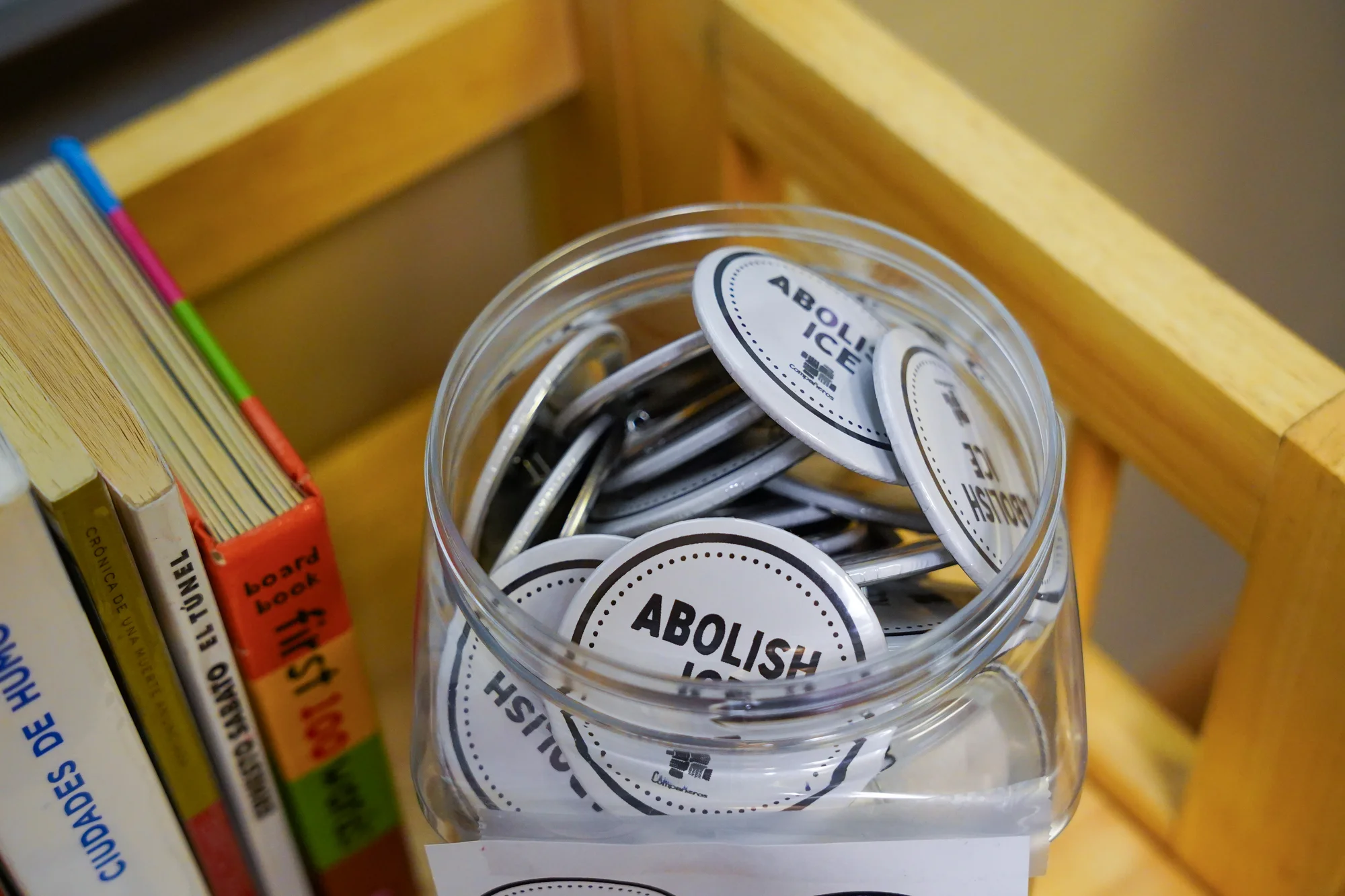 “Abolish ICE” buttons in the Compañeros office. Another button, not pictured, expresses a similar sentiment, but with stronger language. Photo: Joshua Vorse, Rocky Mountain PBS