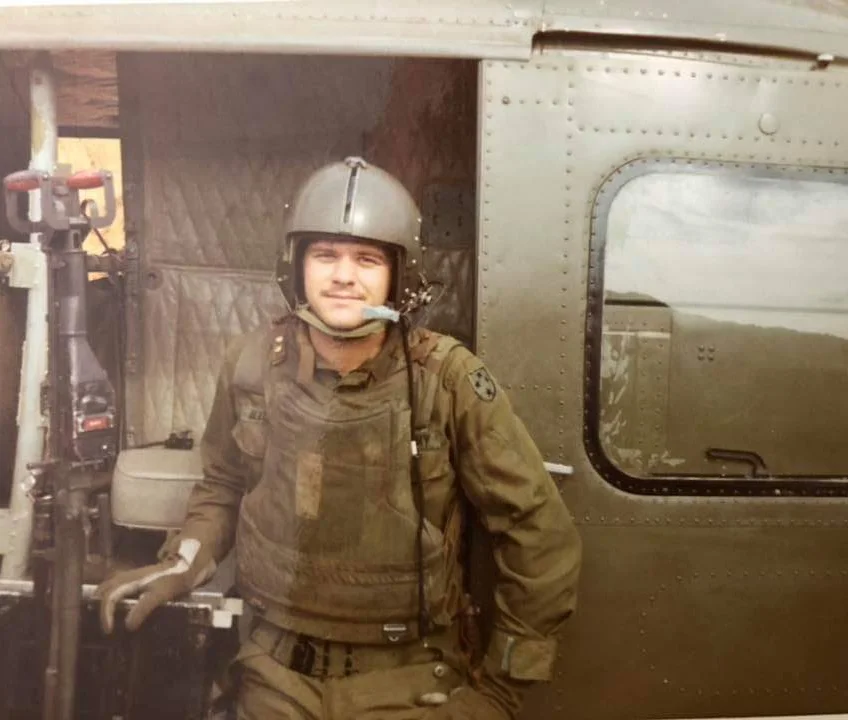 Markley outside of an Army helicopter where he flew as a door gunner. Photo courtesy Danny Markley