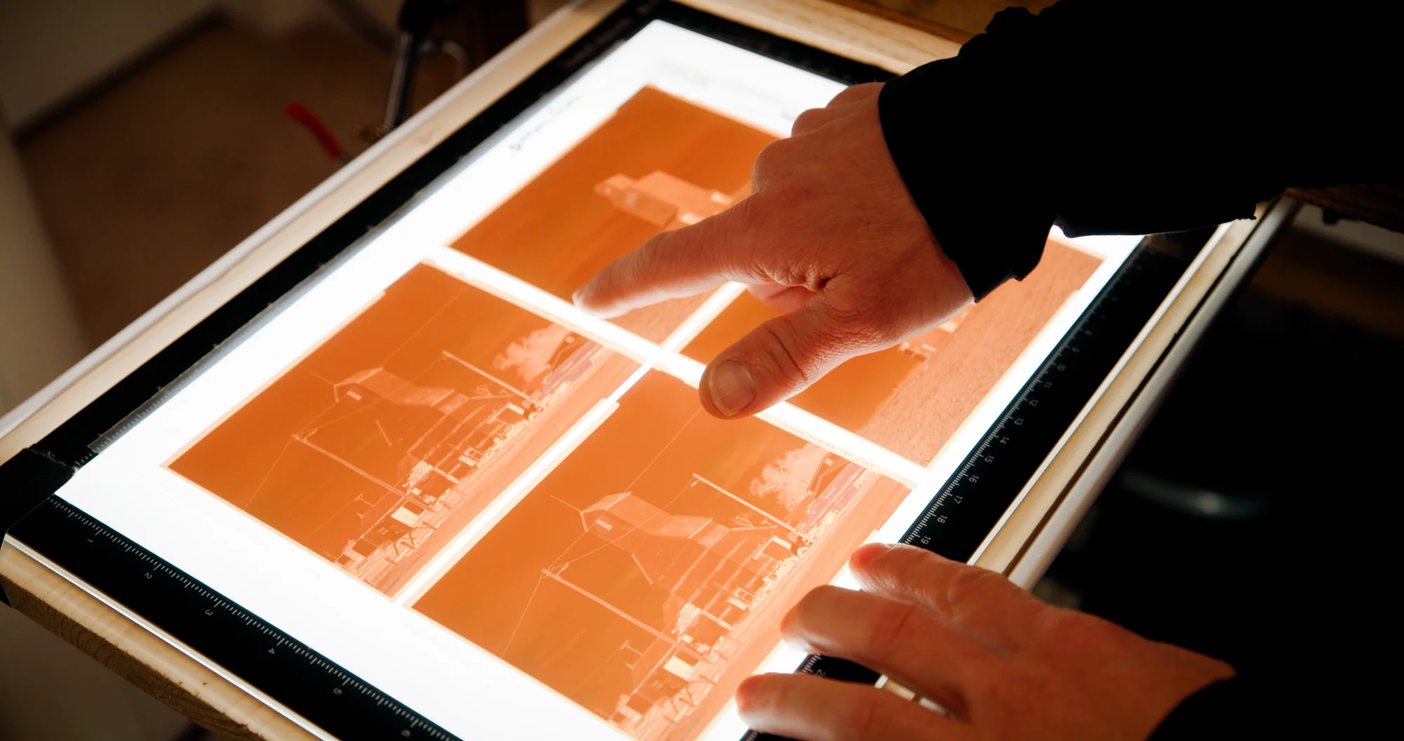 Alex Burke shows a set of negatives at his home in Greeley, CO. Photo: Cormac McCrimmon, Rocky Mountain PBS