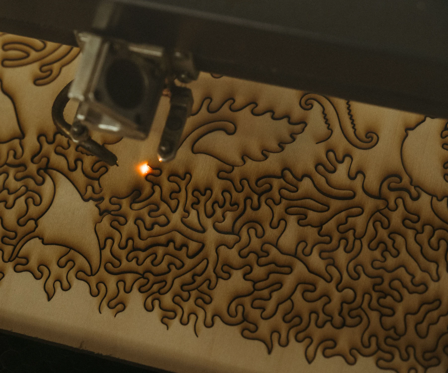 Liberty Puzzles uses a laser to cut its puzzles. Fresh puzzles smell like burnt wood. Photo: Peter Vo, Rocky Mountain PBS