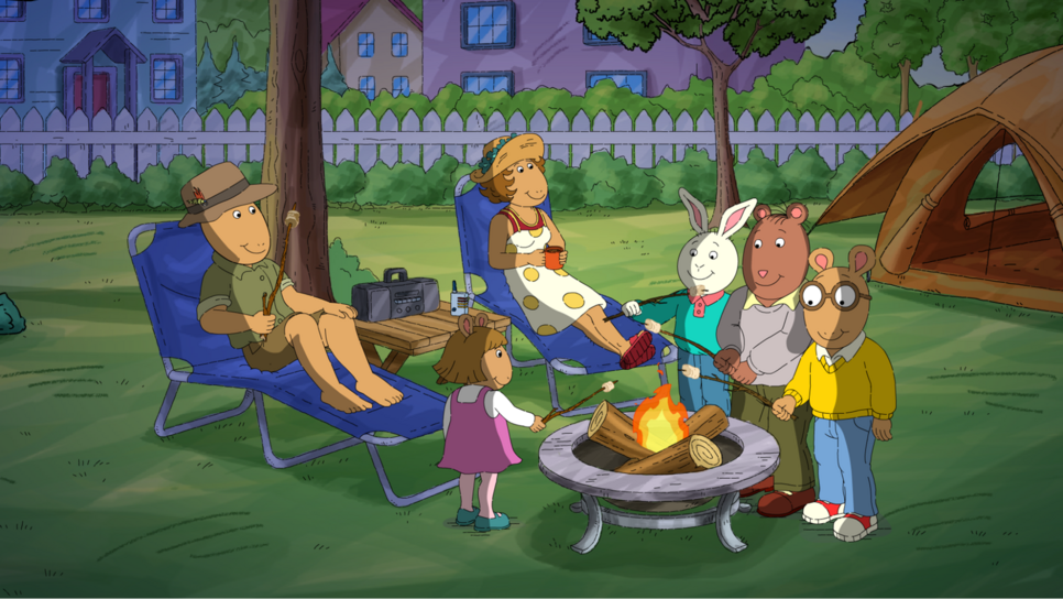 Arthur and family camping and making S'mores