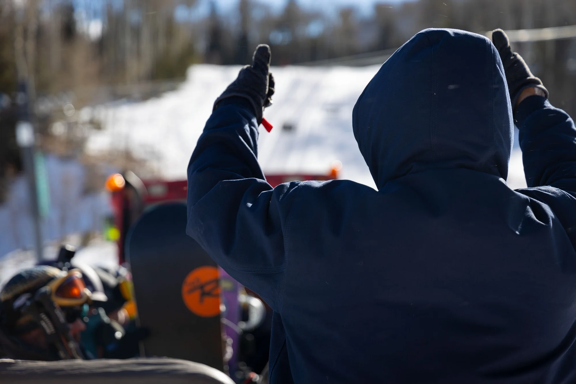 Previous board member-turned volunteer, Jim Littlefield, gives the thumbs up for the Ski Bus driver to begin up the hill. Photo: Chase McCleary, Rocky Mountain PBS