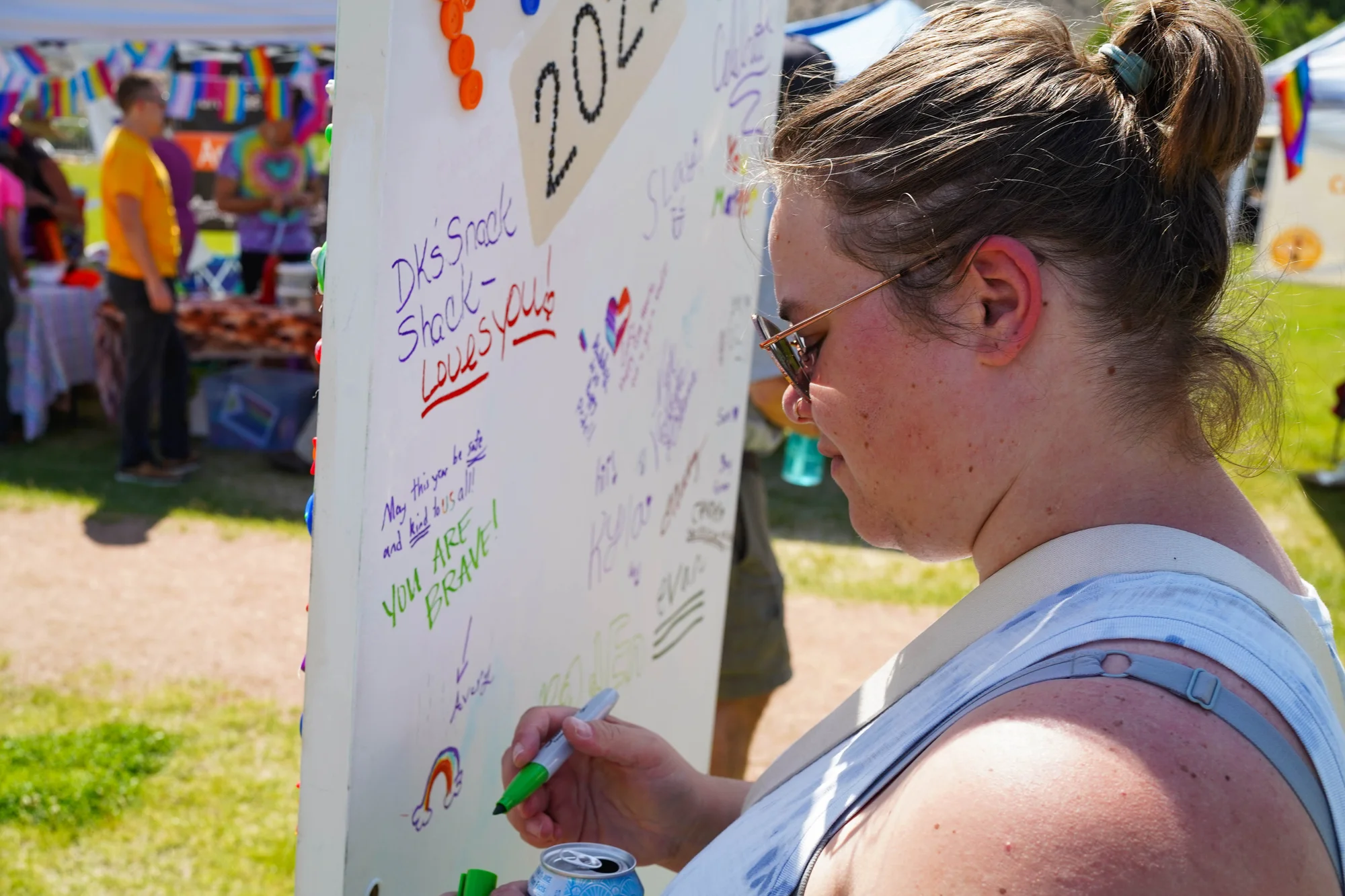 Nikki Strong, from Montrose, writes “you are brave!” on a whiteboard between booths at the event. Photo: Joshua Vorse, Rocky Mountain PBS