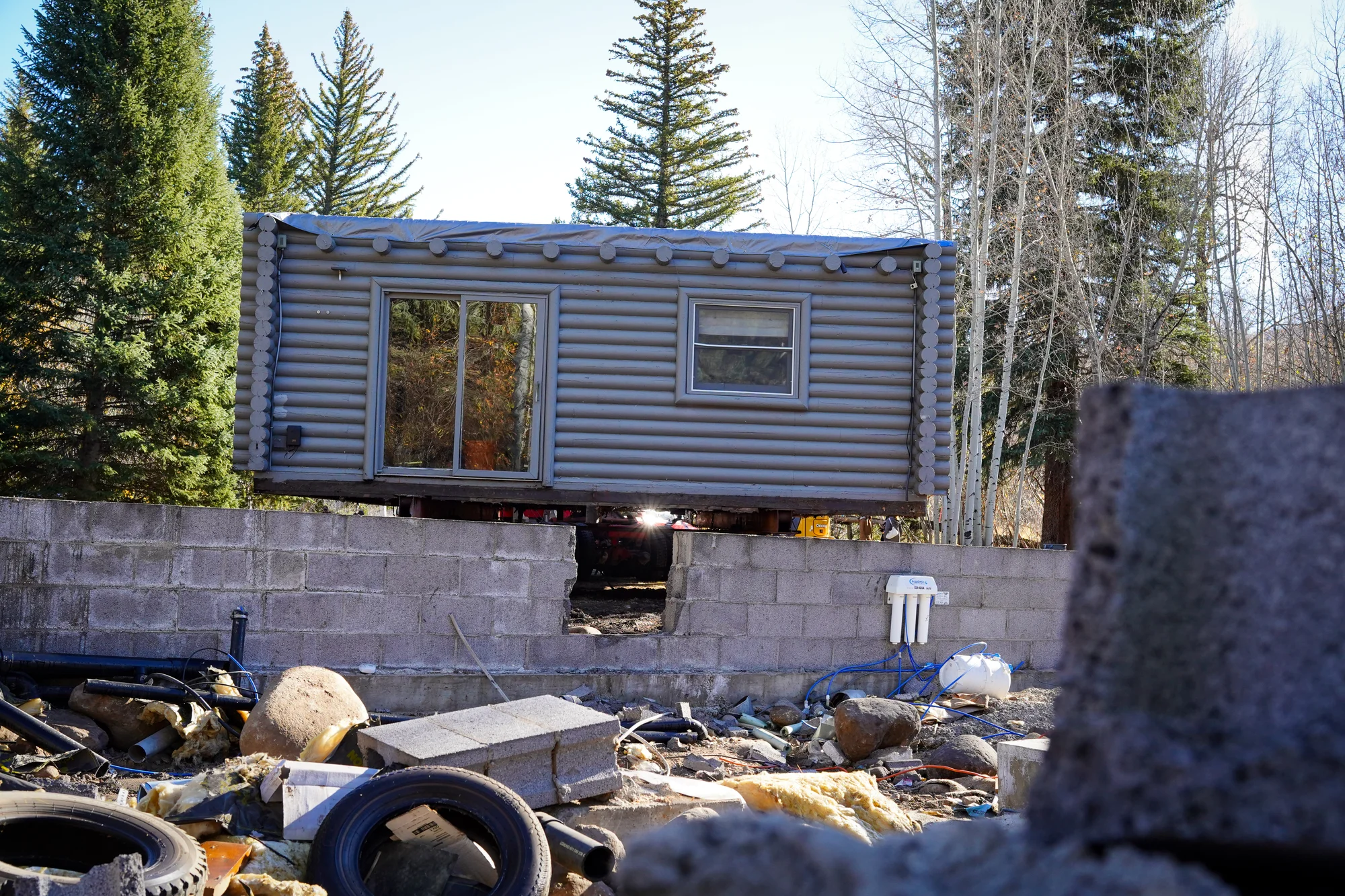 The home sits above its old foundation, awaiting transport. Photo: Joshua Vorse, Rocky Mountain PBS