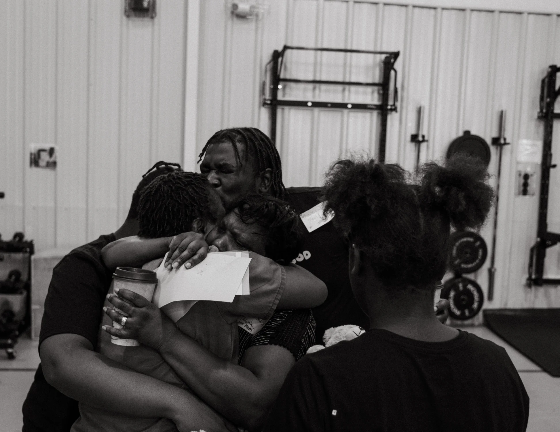 Jael embraces her family before the graduation ceremony. Photo: Peter Vo, Rocky Mountain PBS