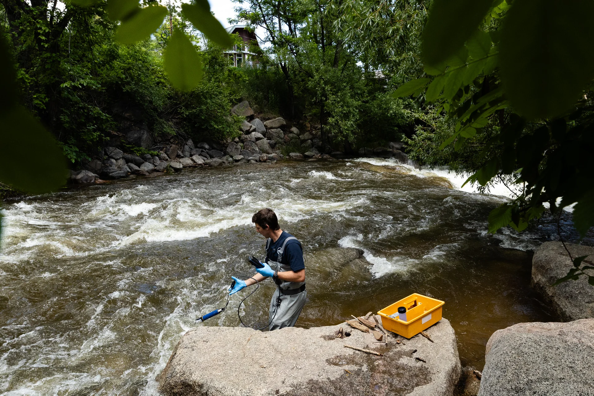  Lawlor wears fishing waders to test the water. Right: Lawlor uses an aquatic probe to test the creek near Eben G. Fine Park. In addition to collecting water samples, he collects data on the river temperature, pH and conductivity.