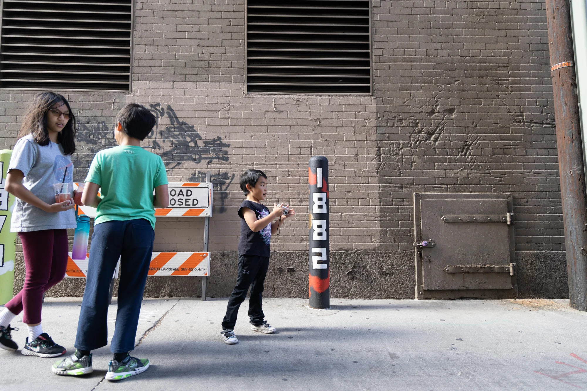 Students with Asian Girls Unite helped Chu design the traffic bollards. “It was really, really important that this project really be from the community and involve a youth voice,” said Chu. The bollards in the alley were designed to create a walking timeline of important dates from the Asian American community in Colorado. Photo: Andrea Kramar, Rocky Mountain PBS