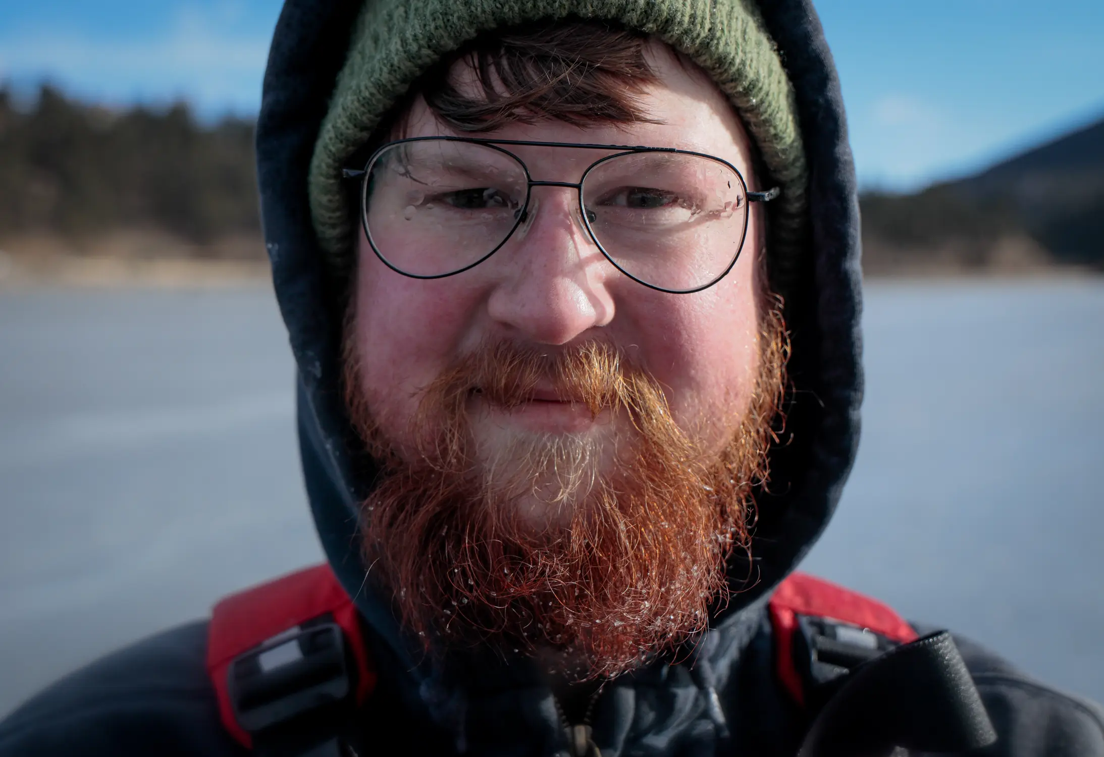 Water droplets stick to Jonathan Florence’s glasses after working the hose at Evergreen Lake. Photo: Cormac McCrimmon, Rocky Mountain PBS