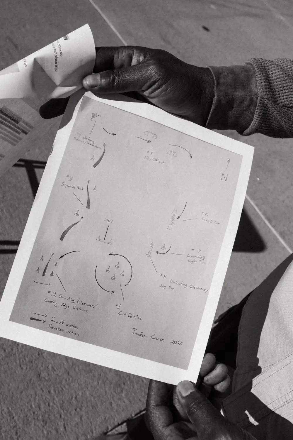 Andray Thomas holds up a map of the obstacle course. The course is designed to simulate real-world conditions that drivers will encounter during major storms. Photo: Peter Vo, Rocky Mountain PBS