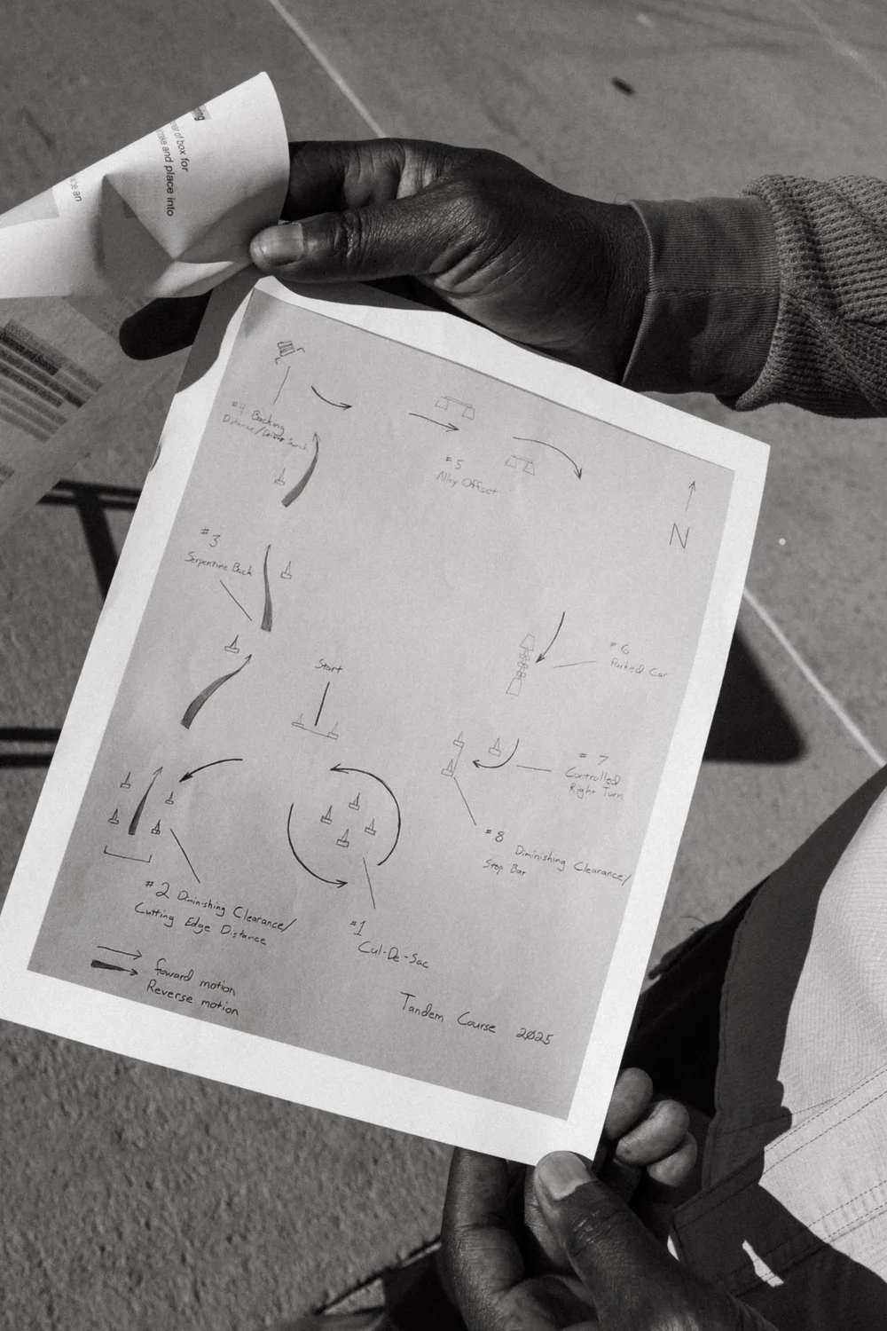 Andray Thomas holds up a map of the obstacle course. The course is designed to simulate real-world conditions that drivers will encounter during major storms. Photo: Peter Vo, Rocky Mountain PBS