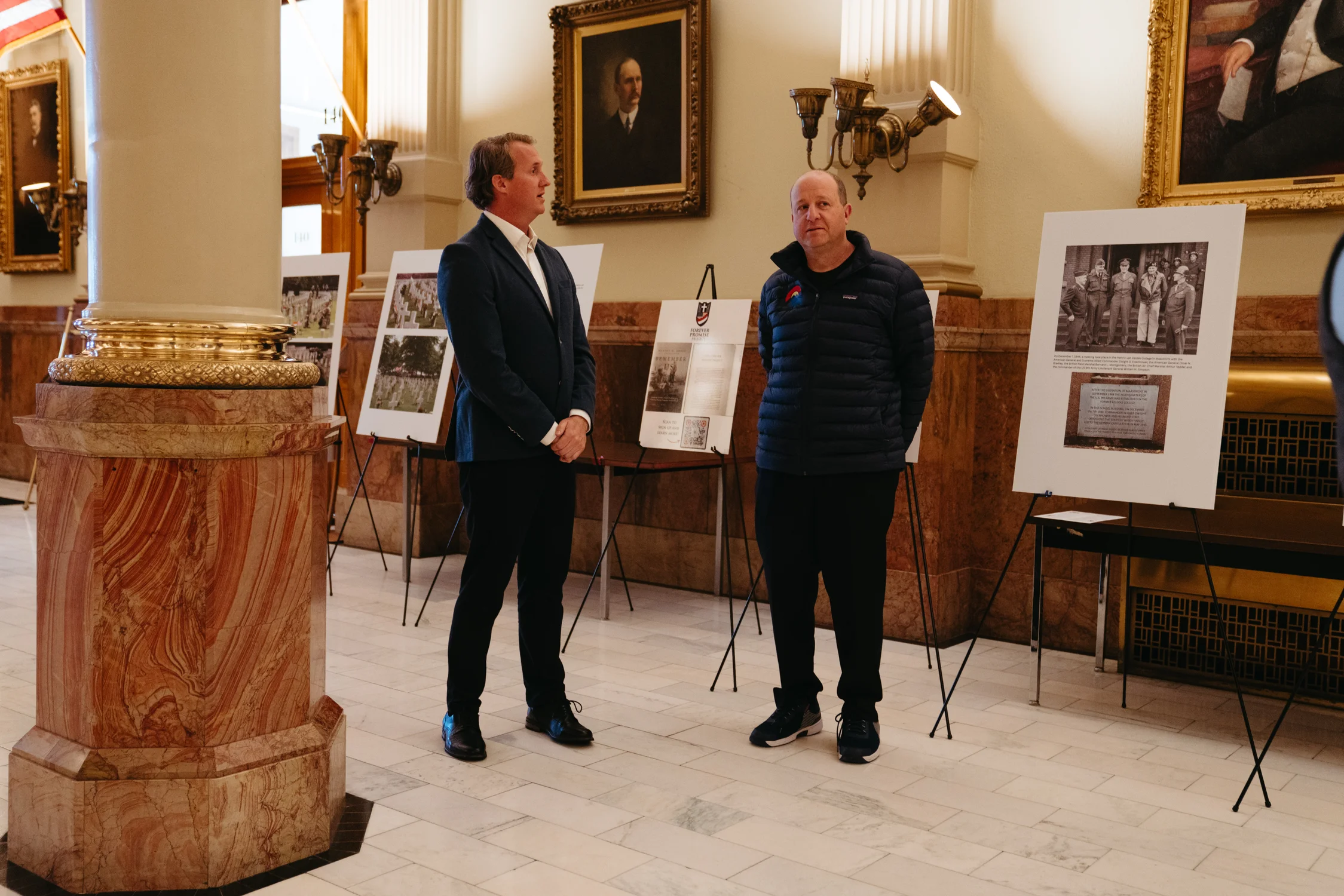 Adrian Charbonnet (left) greeted Colorado Governor Jared Polis (right) when he visited the exhibit. Photo: Adrian O'Farrill, Rocky Mountain PBS