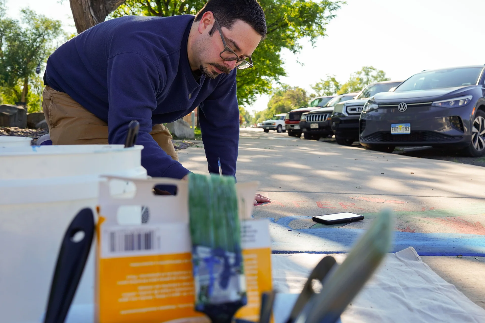 Three artists, including West, painted nature scenes on the sidewalk next to some of them to remind people to do their part. Photo: Joshua Vorse, Rocky Mountain PBS