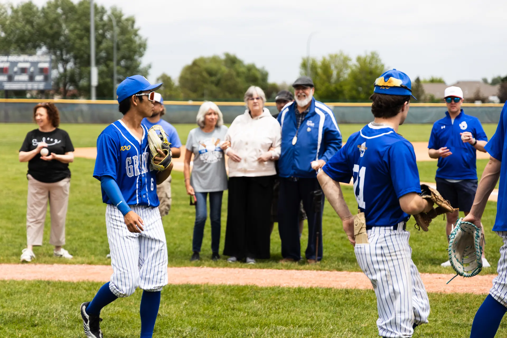 Former Greeley Grays players or families of former players threw out first pitches ahead of the 100 year anniversary game. Photo: Amanda Horvath, Rocky Mountain PBS