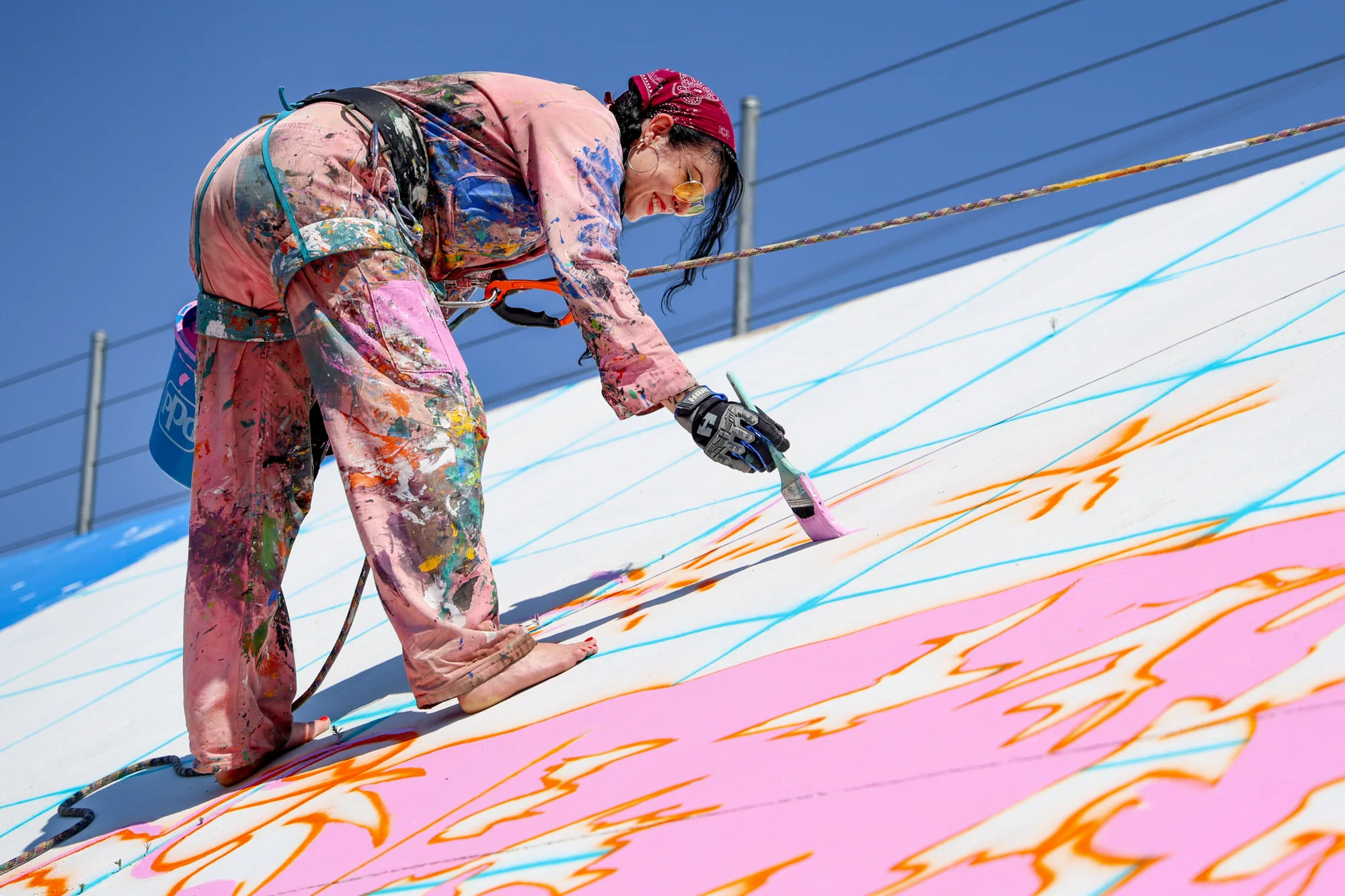 Artist Shannon Palmer paints on the Arkansas River levee. Photo: Priya Shahi, Rocky Mountain PBS