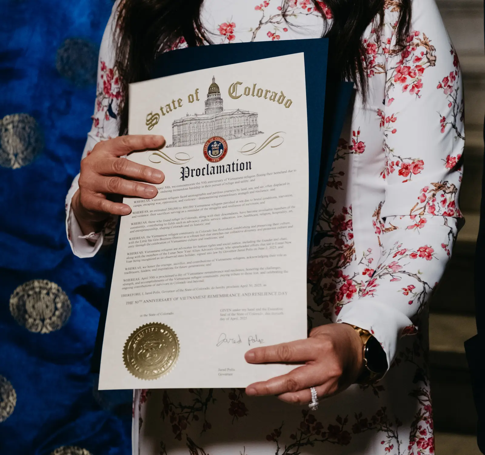 Nga Vương-Sandoval holds the proclamation. Photo: Peter Vo, Rocky Mountain PBS