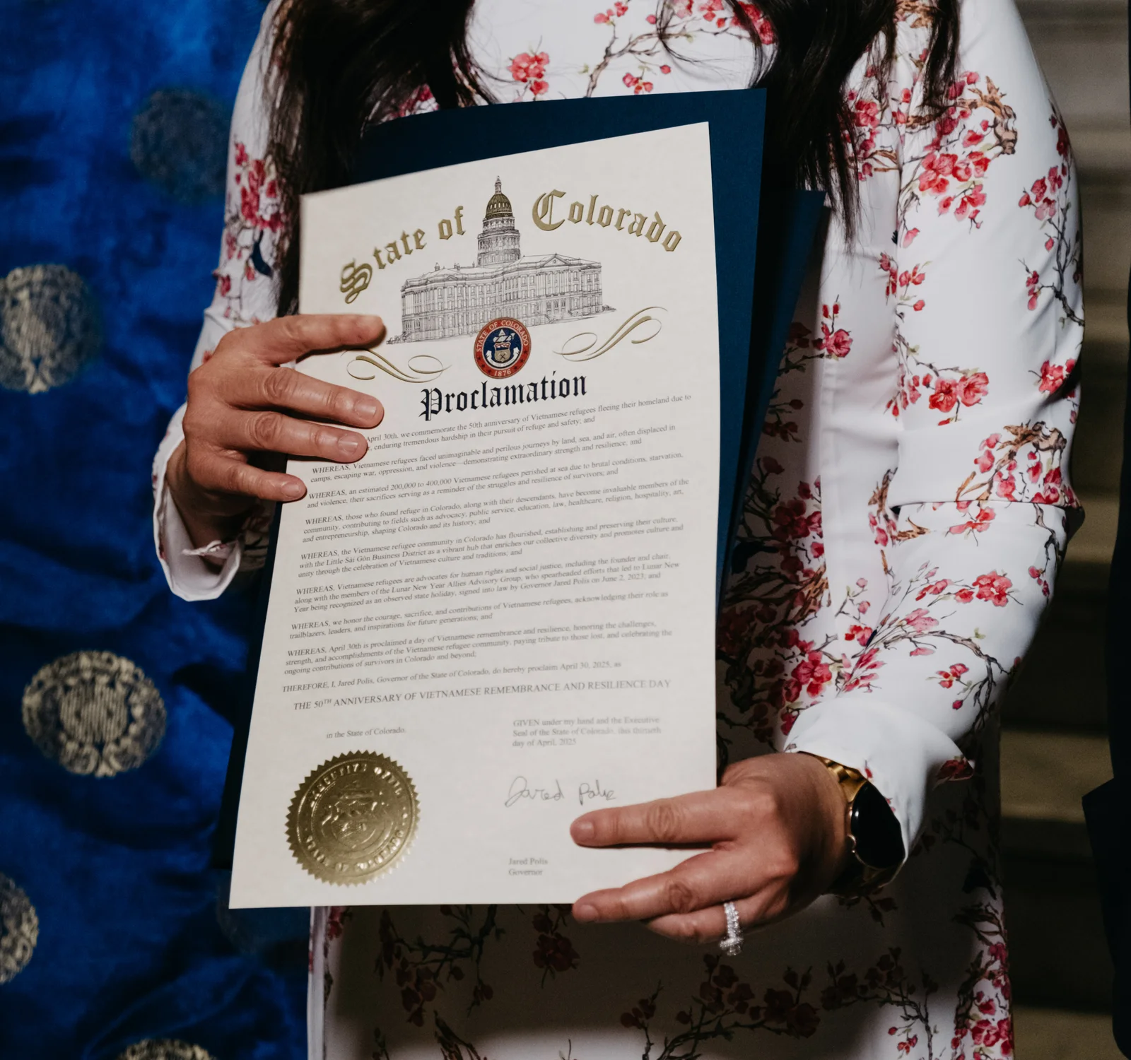 Nga Vương-Sandoval holds the proclamation. Photo: Peter Vo, Rocky Mountain PBS