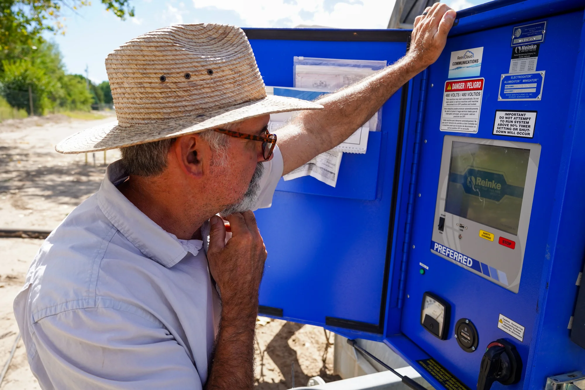 Cabot at the control box of the irrigation system at the research station in Fruita. Photo: Joshua Vorse, Rocky Mountain PBS