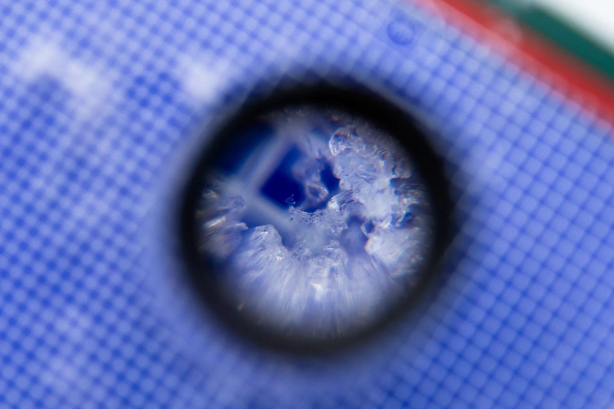 Using a magnified-loupe, Shaedig photographs the snow crystals. Photo: Cormac McCrimmon, Rocky Mountain PBS