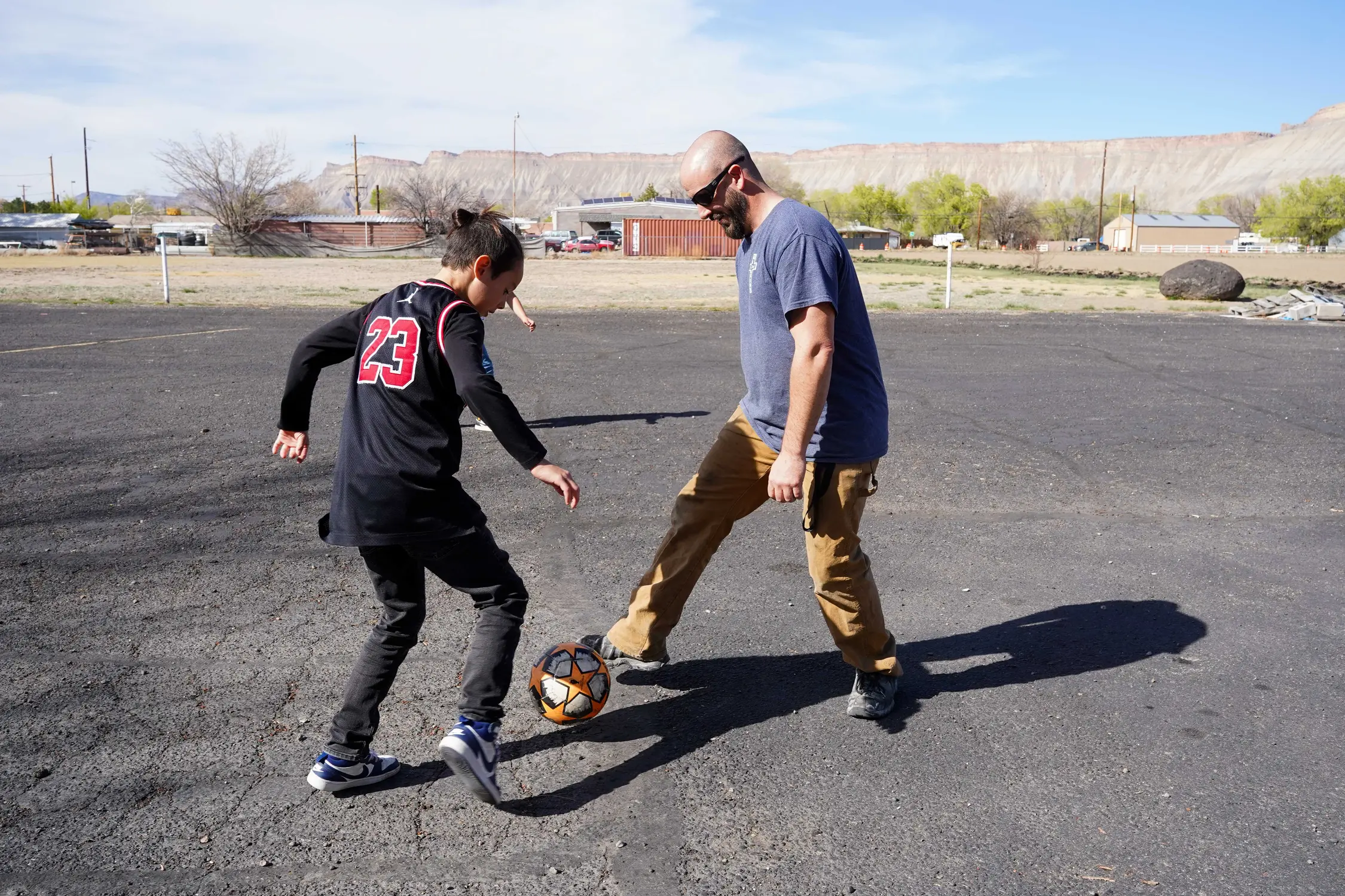 Pete Nuncio, 10, plays soccer with Jared Compton, the high school youth pastor at Clifton Assembly of God, who volunteers at The Hub on Mondays. Photo: Joshua Vorse, Rocky Mountain PBS
