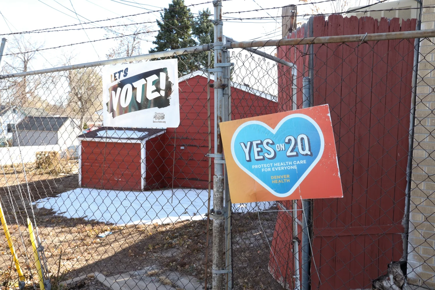 Election signs posted on the fence outside of Re:Vision’s office on Morrison Road in Westwood. Photo: Carly Rose, Rocky Mountain PBS.