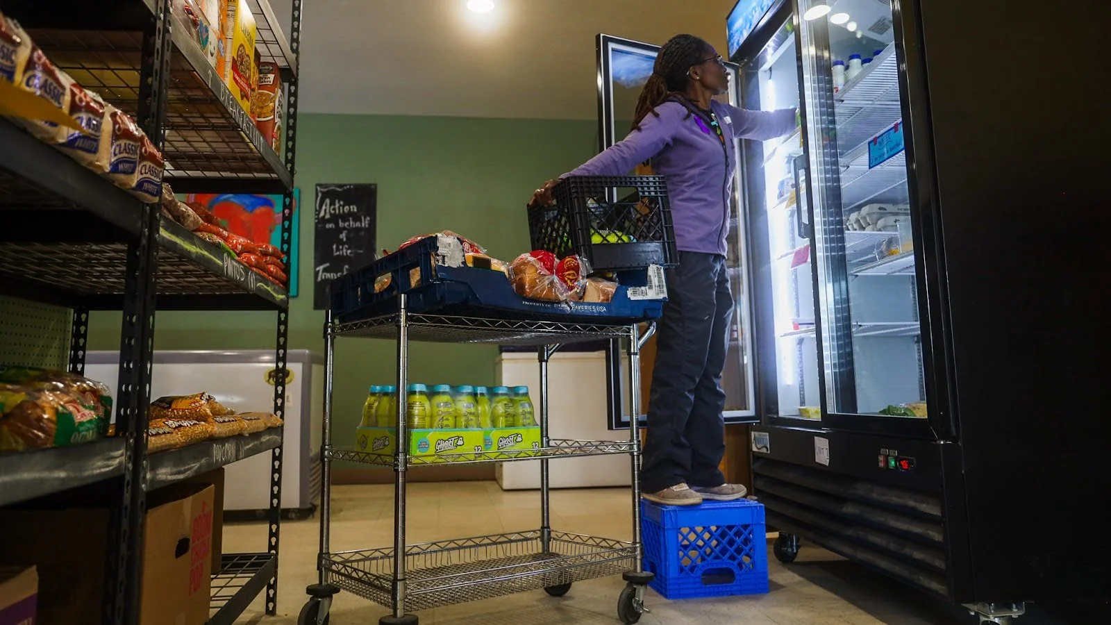 Brenda Henderson stocking the fridge. Photo: Ziyi Xu, Rocky Mountain PBS