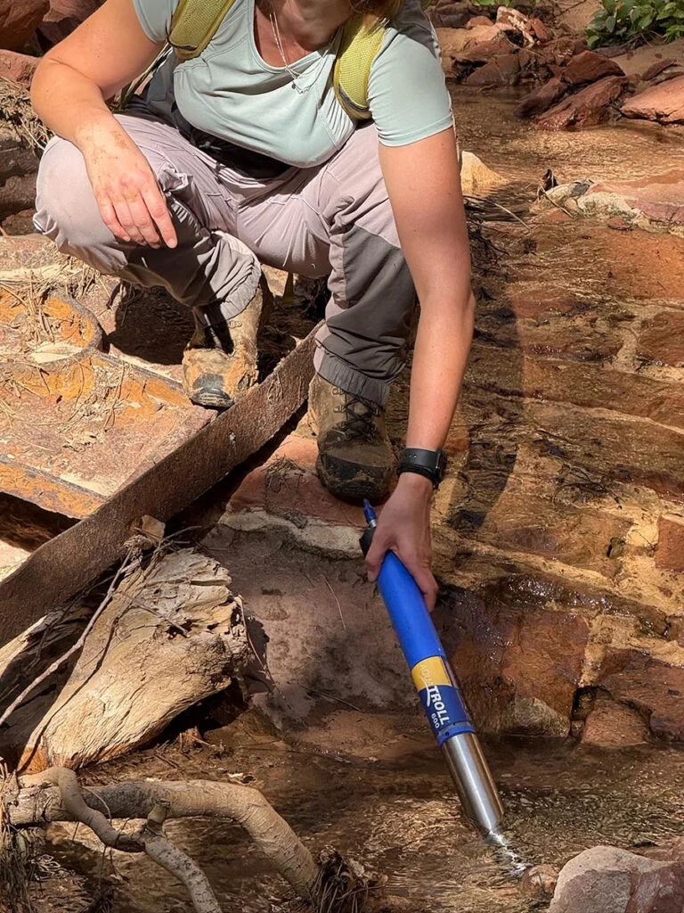 Katie Willi collects water quality data at a spring water source in Zion National Park. Photo courtesy of Kristen Cognac
