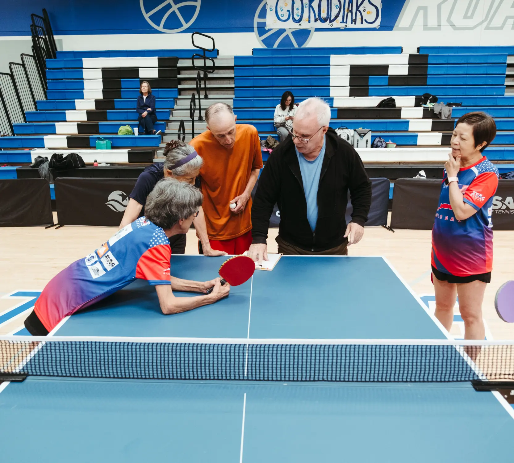 Marion Caldwell discusses tournament regulations with an official at the Colorado Senior Games tennis tournament. Photo: Peter Vo, Rocky Mountain PBS