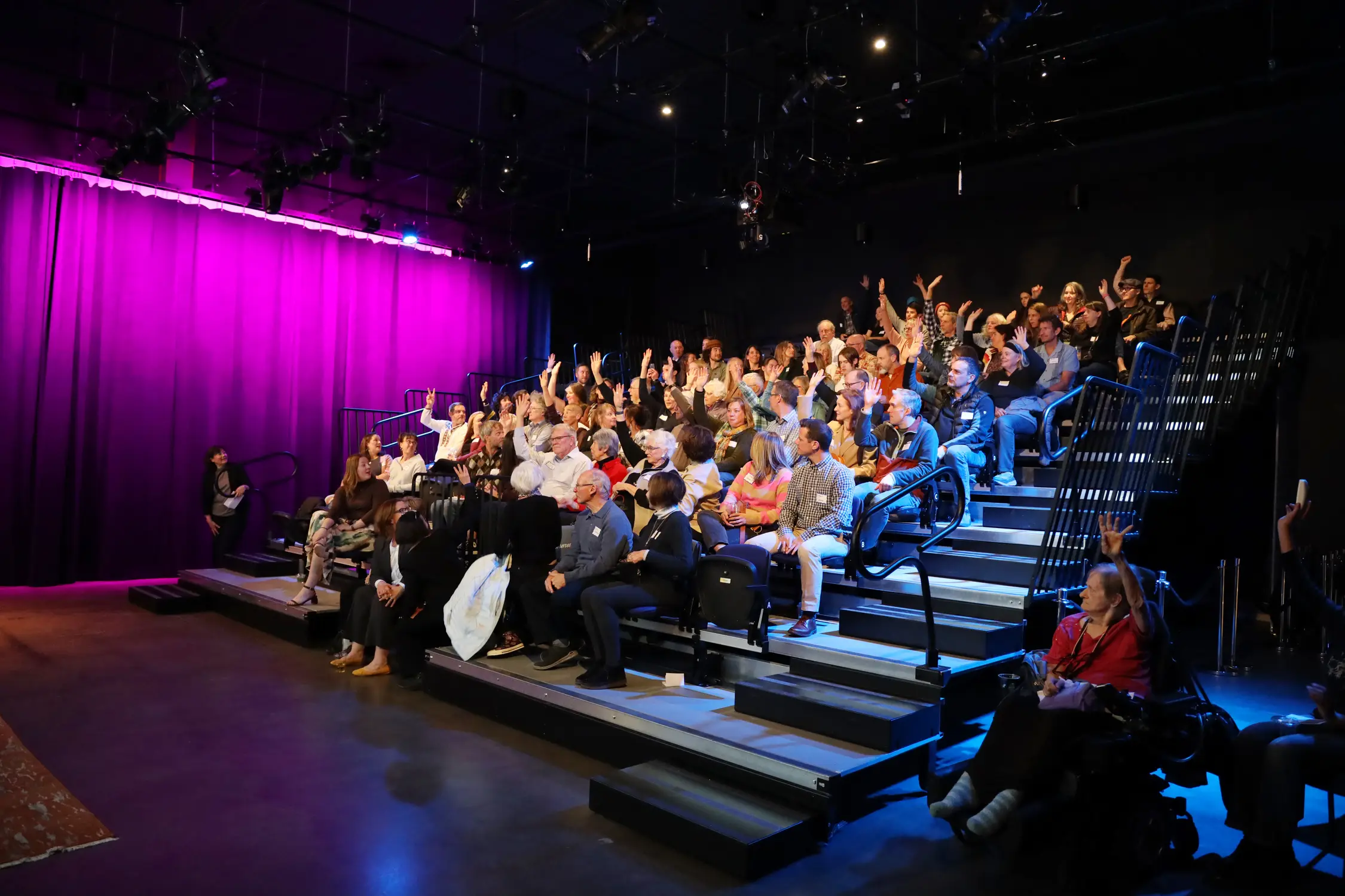 Audience members at Buell Public Media Center raised their hands if they volunteered with the Peace Corps. Photo: Amanda Horvath, Rocky Mountain PBS