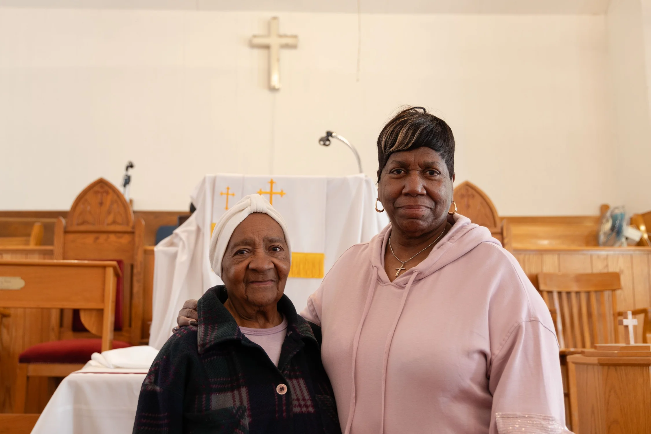 Lemon (left) and Hector (right) stand before the First AME pulpit. Photo: Chase McCleary, Rocky Mountain PBS