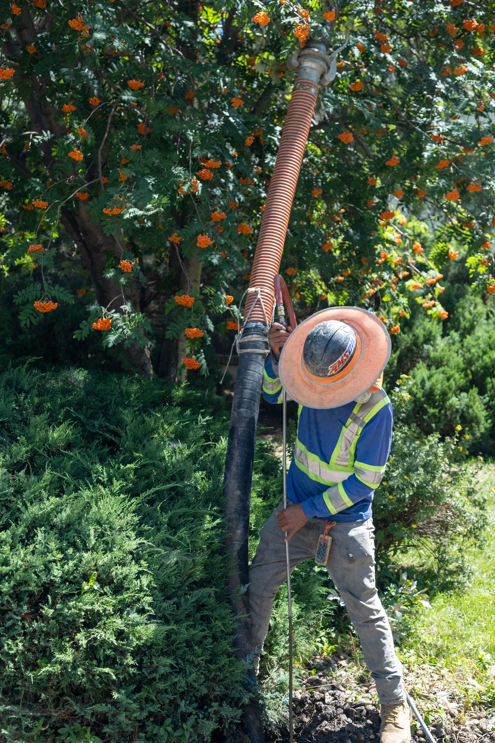 Construction workers make room for fiber optic conduit while navigating other wires underground. Photo: Chelsea Casabona, Rocky Mountain PBS