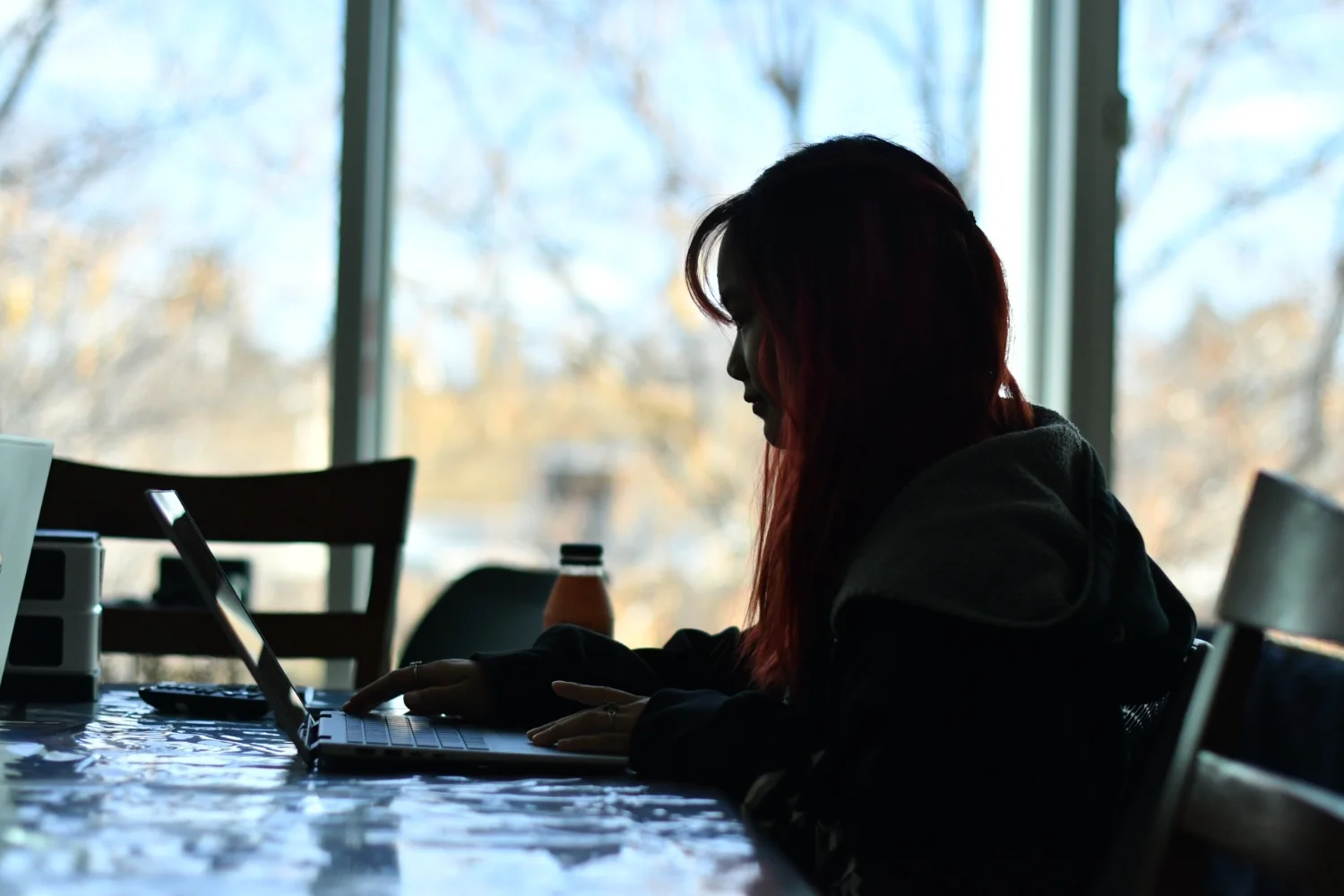 Laras Prasetya works on homework in between classes at the Asian Pacific American Cultural Center at Colorado State University. Photo: Cormac McCrimmon, Rocky Mountain PBS