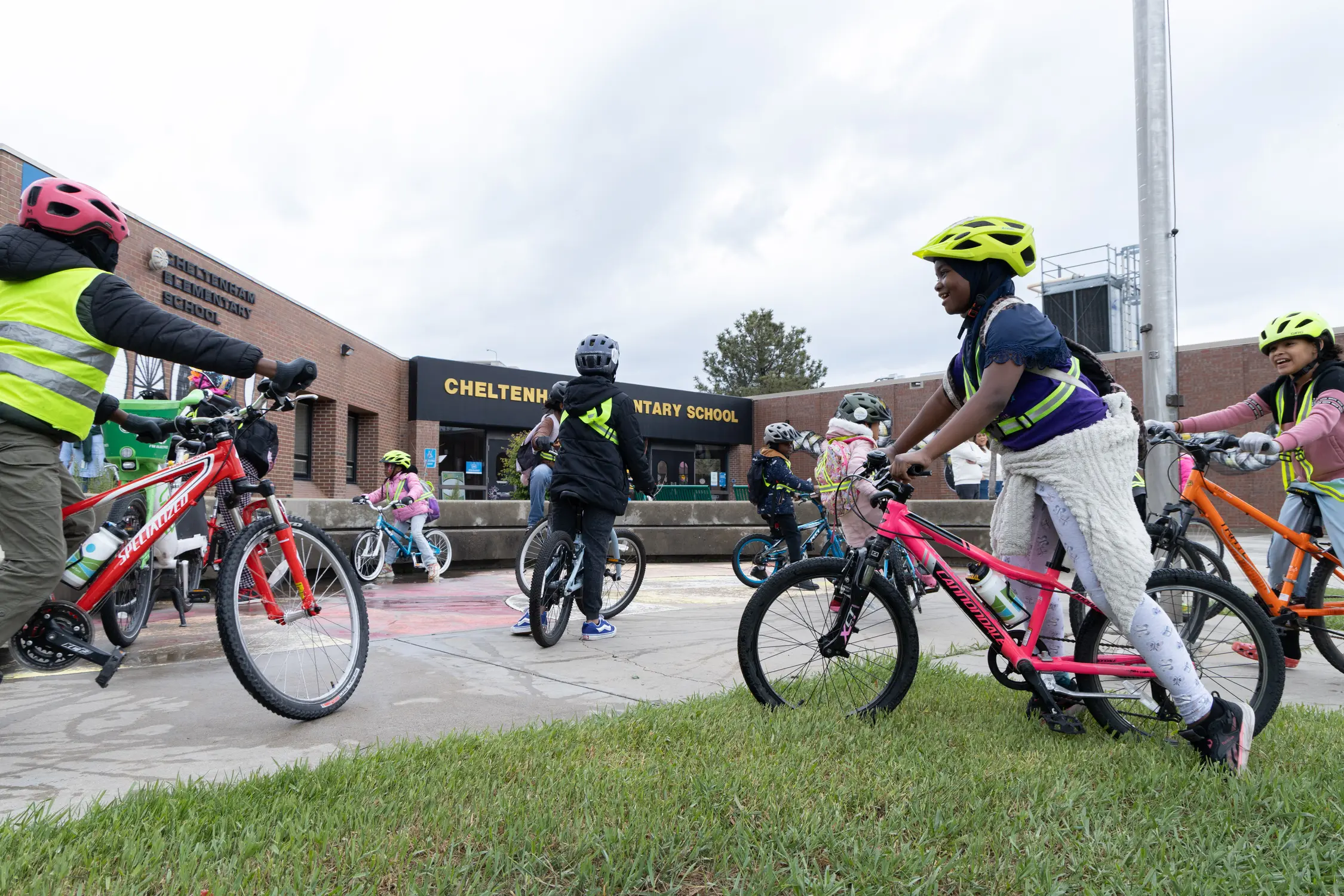 Students outside Cheltenham Elementary School arrive on bikes. Photo: Andrea Kramar, Rocky Mountain PBS