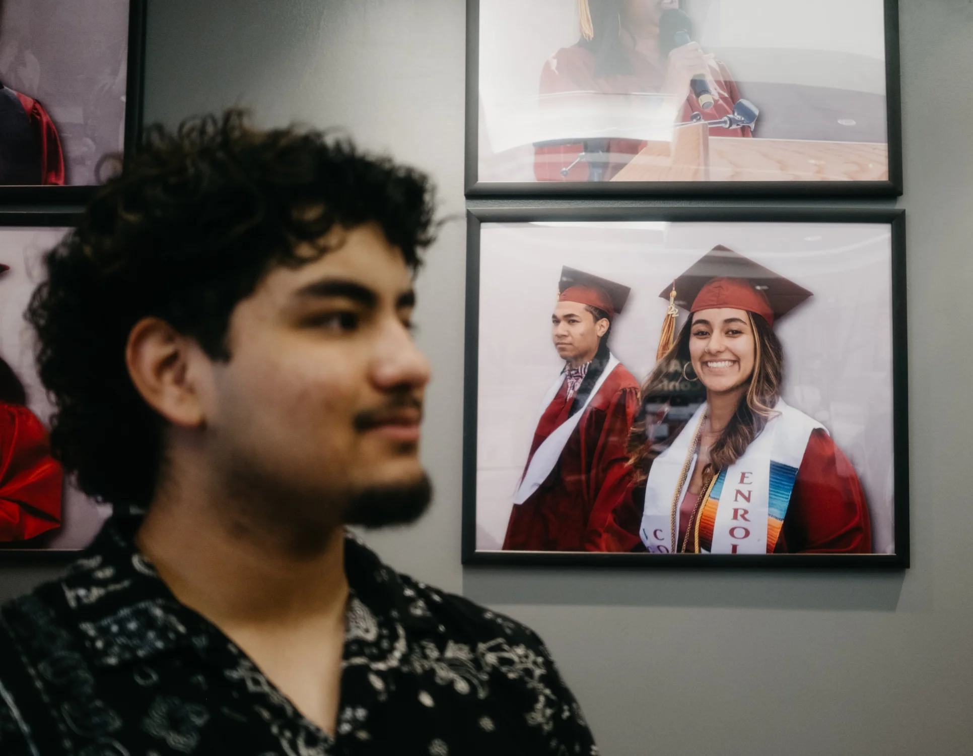 Carlos Robles sits in front of a portrait of his older sister, Valerie, who also participated in the concurrent enrollment program. Photo: Peter Vo, Rocky Mountain PBS