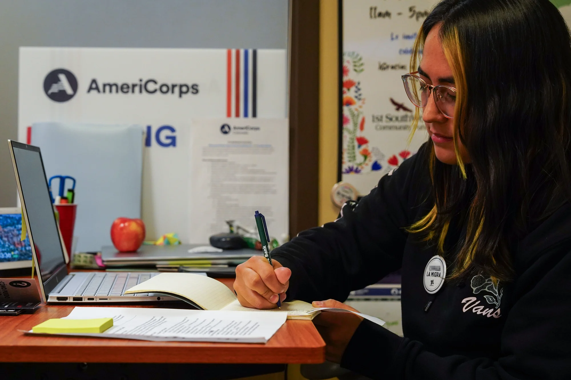 Youth programs expansion coordinator Brenda Gutierrez Ruiz works in the Compañeros office. Photo: Joshua Vorse, Rocky Mountain PBS