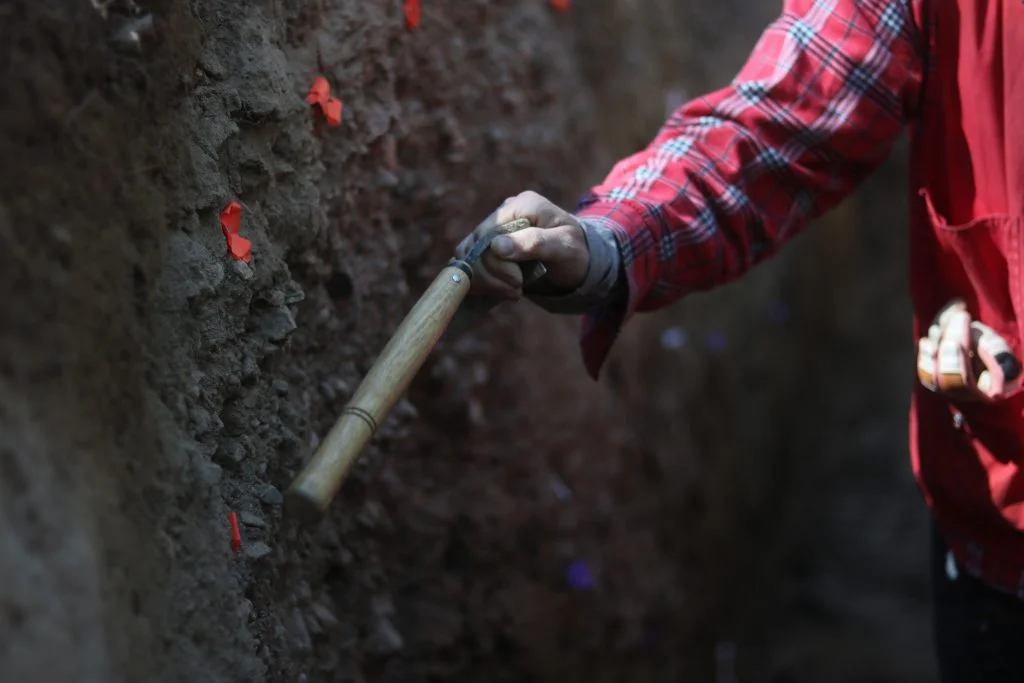 A scientist investigating the Gore Range fault uses a tool to point out a layer in the subsurface Friday, Sept. 6, 2024. The scientists are attempting to estimate the date of the last earthquake to occur in the area. Photo: Ryan Spencer, Summit Daily News