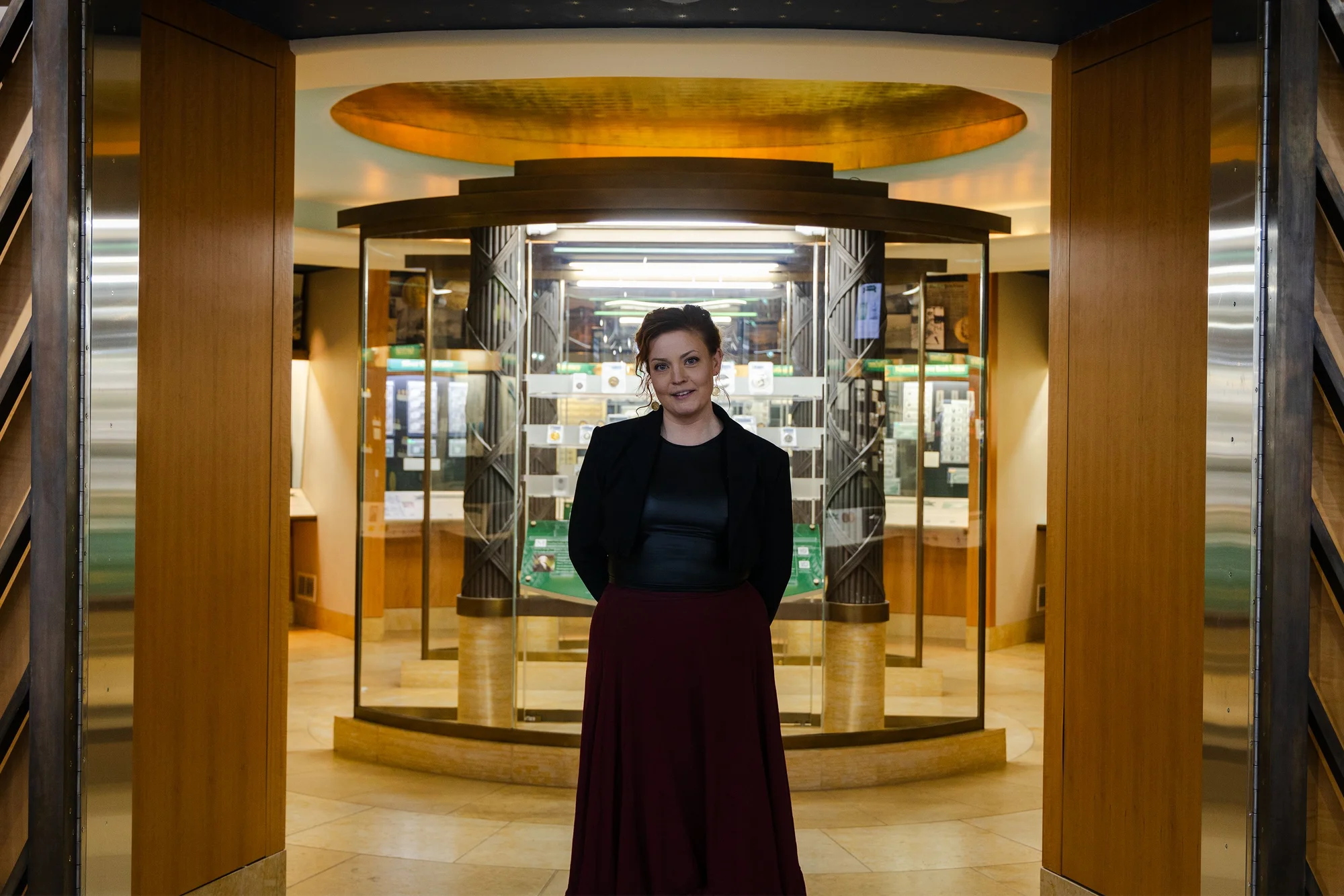 Turco (pictured) before the Money Museums’ American Gallery, which features coins from throughout American history. Photo: Chase McCleary, Rocky Mountain PBS