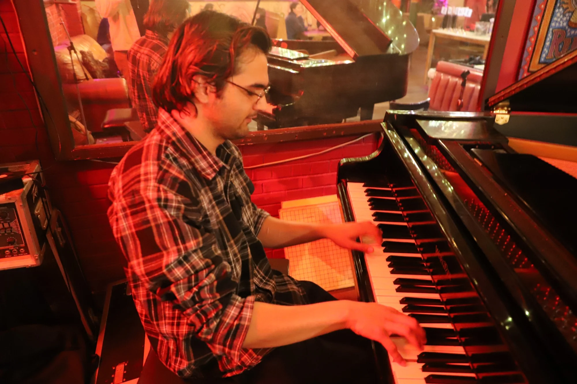 Zain Najeebi plays the piano four times a week at Mercury Cafe. Photo: Alec Berg, Rocky Mountain PBS