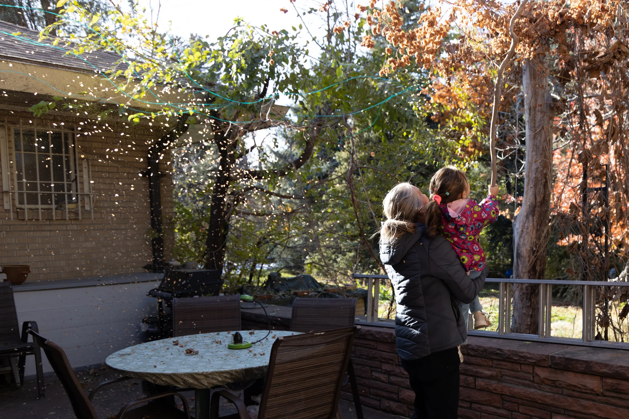 Volunteer Danica Larson plays with Hedayat Yar and Mohammadi’s four-year-old daughter in her backyard. Photo: Andrea Kramar, Rocky Mountain PBS