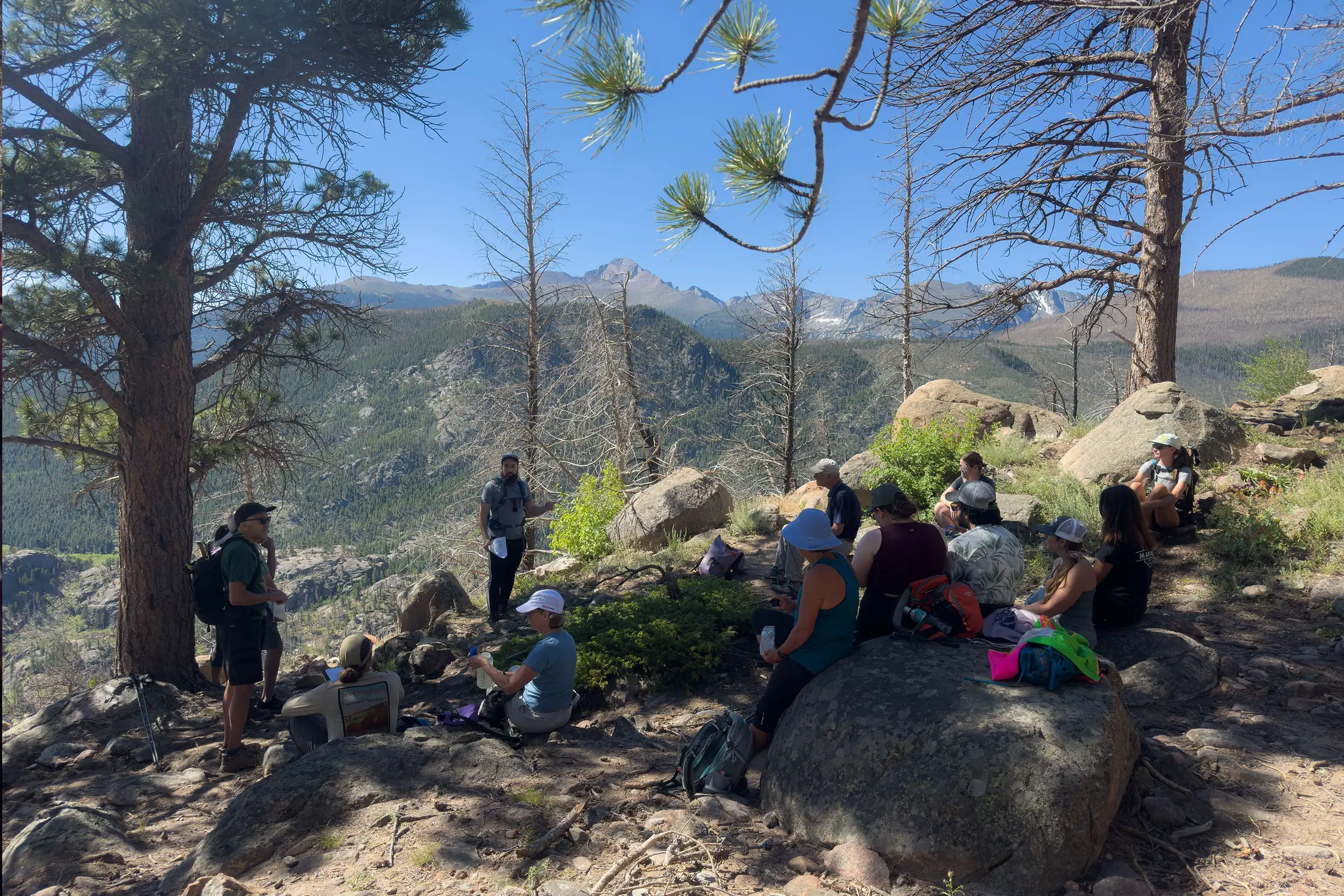 Auerbach (center, talking) addressed hikers at various points along the trail. Photo: Chase McCleary, Rocky Mountain PBS