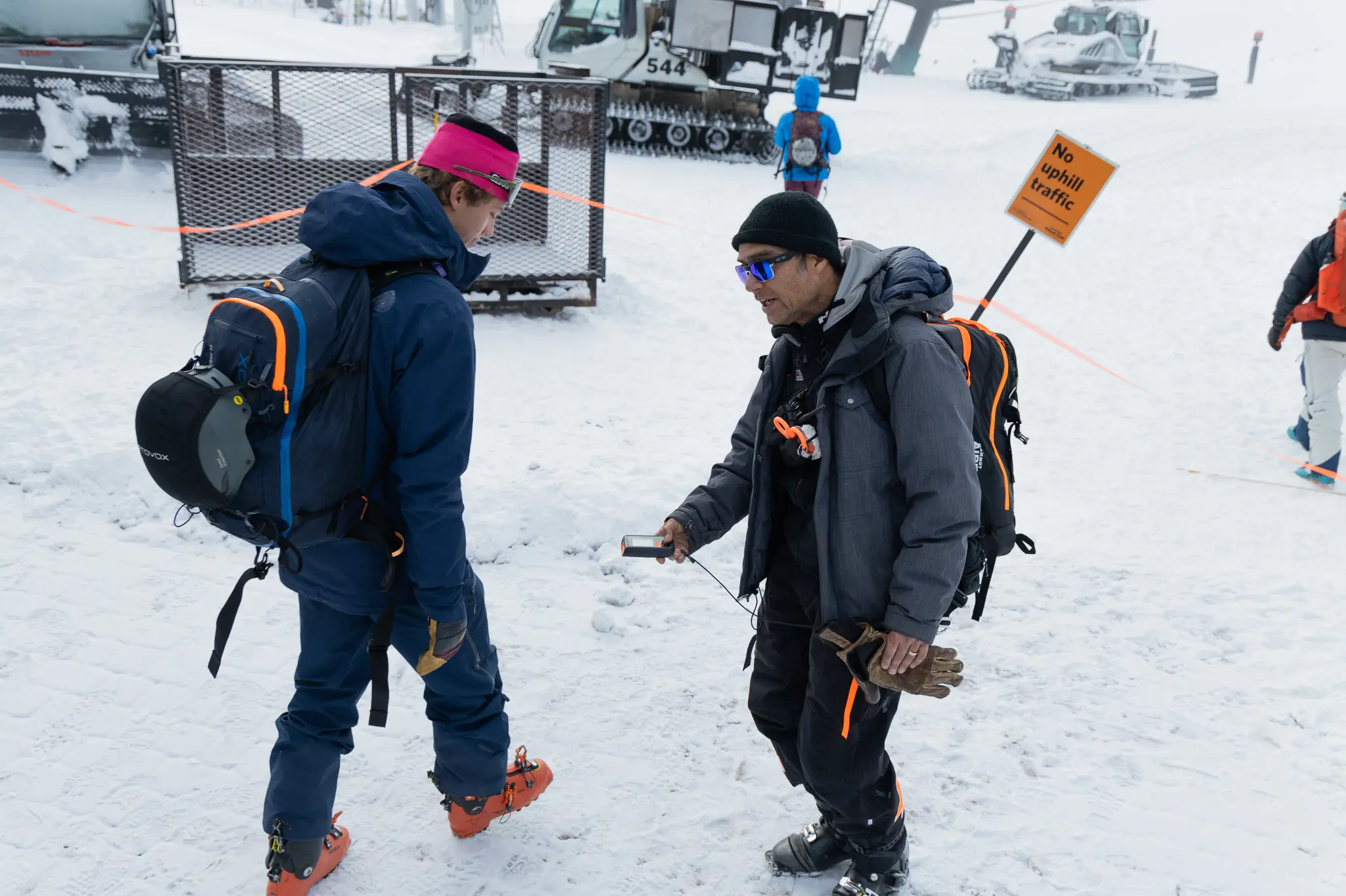 Bootpackers are required to wear an avalanche beacon while working. Ski patrollers perform a beacon check before workers ride a chairlift to the work location. Photo: Cormac McCrimmon, Rocky Mountain PBS