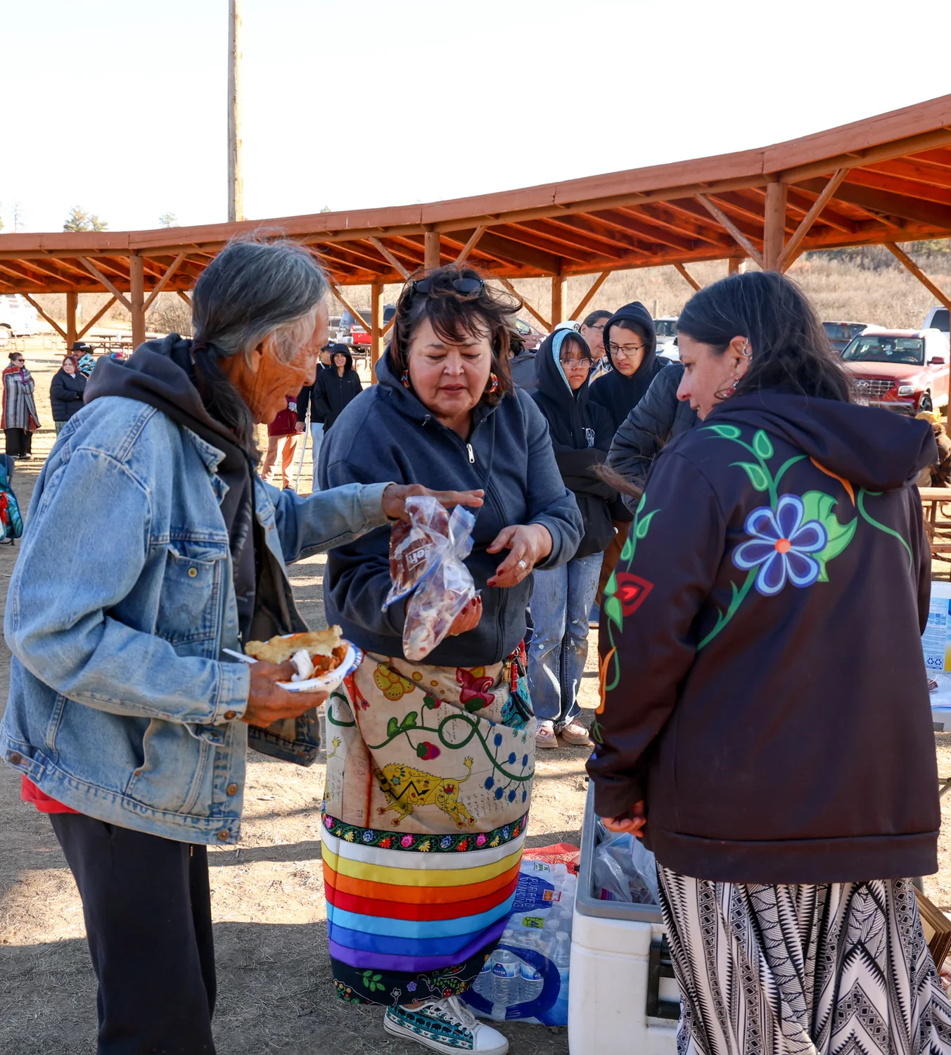 Elderly Indigenous people line up first for the bison meat distribution. Photo: Priya Shahi, Rocky Mountain PBS