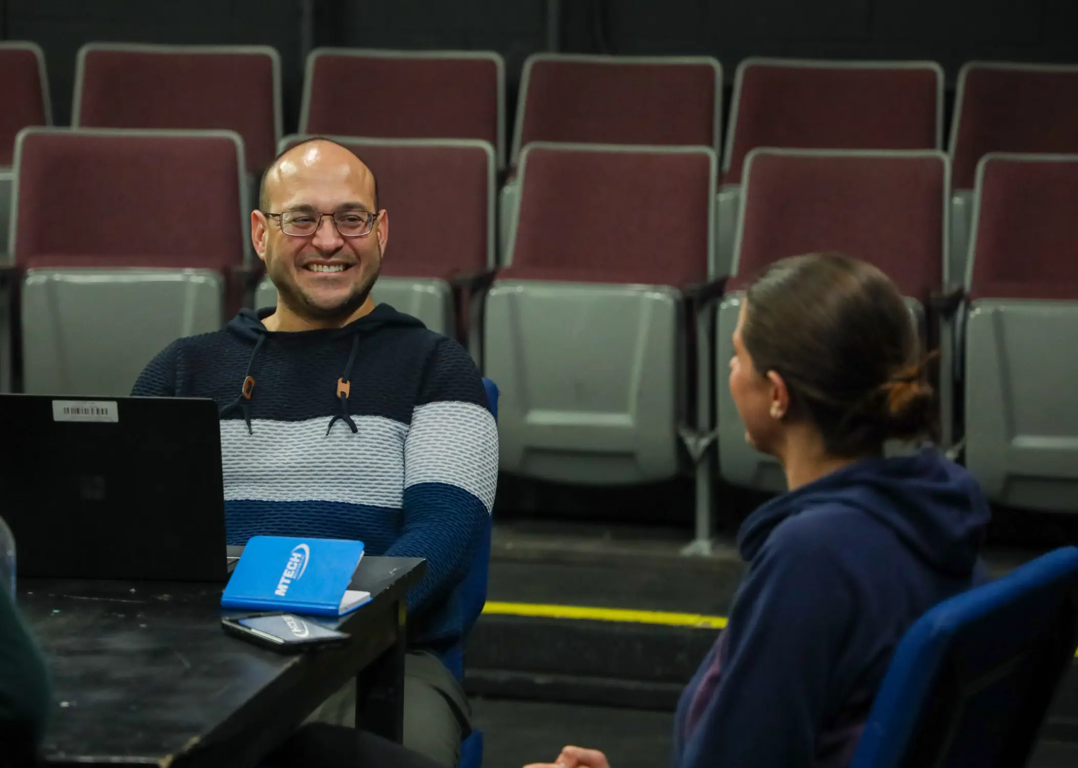 Flamboyán Theatre founder Jonathan Marcantoni laughs with Nicole Caron during a rehearsal for the Puerto Rican political satire “We Reserve the Right of Admission” in February 2025. Photo: Carly Rose, Rocky Mountain PBS