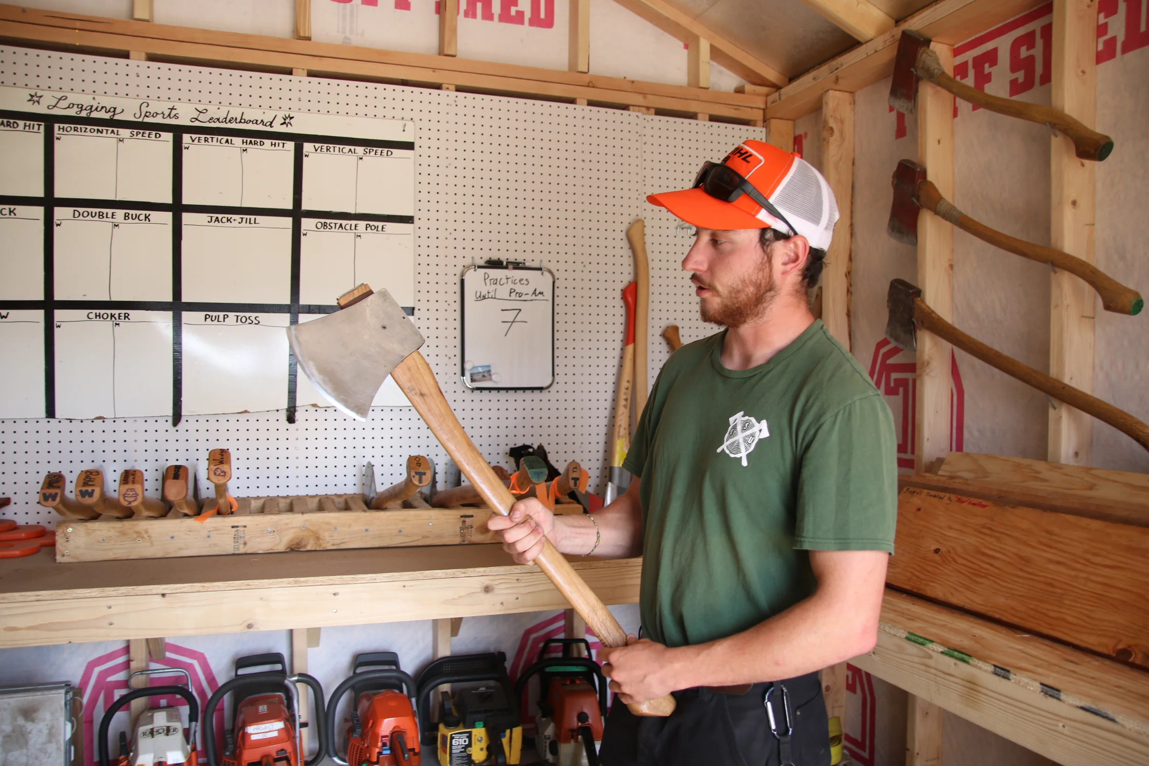 Inside the axe shed, Troy Ferguson holds up a trainer axe that beginners start on before moving up to something heavier. They're practicing for their competition coming up at the end of April in Missoula, Montana. Photo: Emma VandenEinde, KUNC