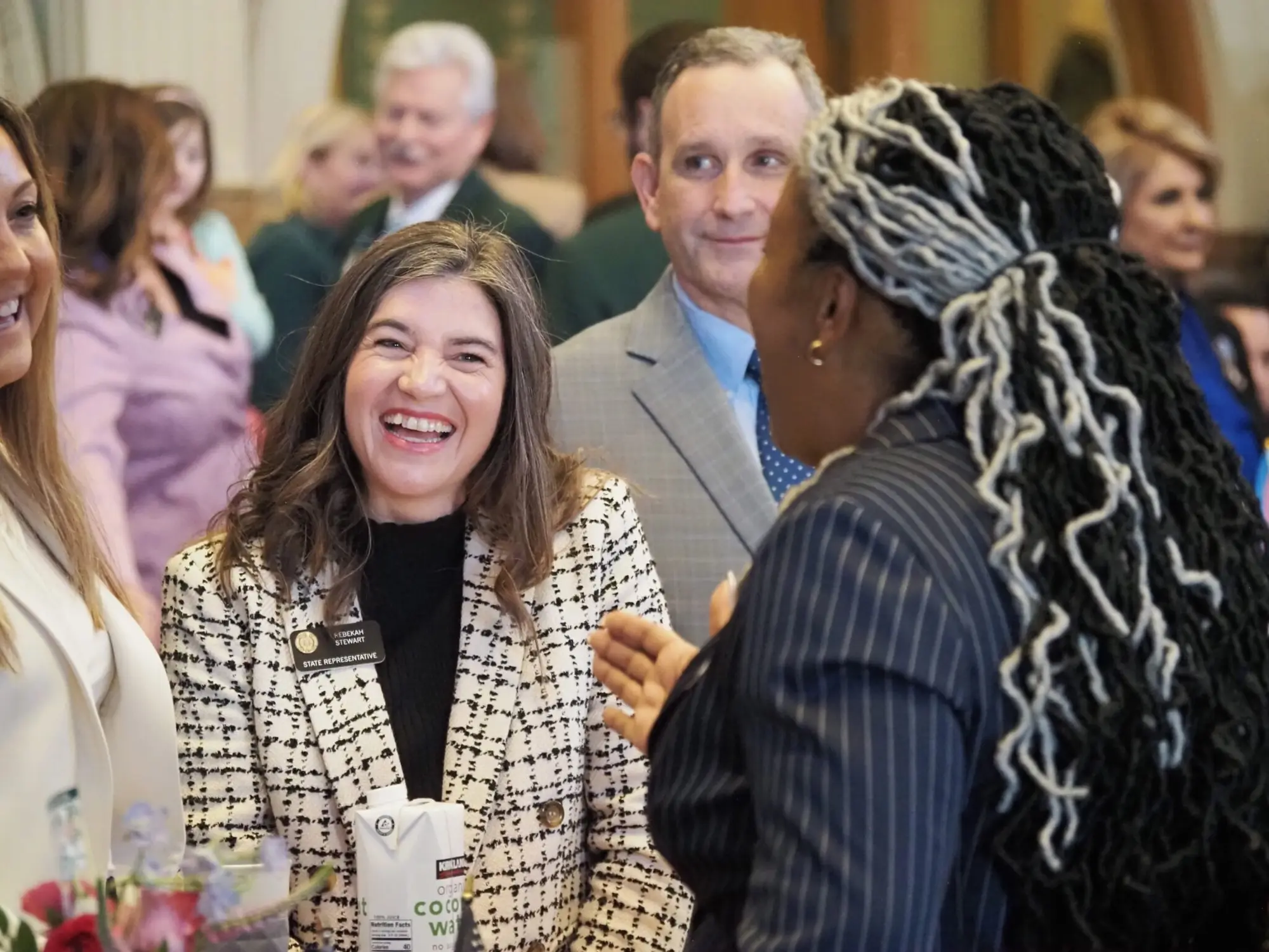 Colorado state Rep. Rebekah Stewart, a Lakewood Democrat, laughs while talking to state Rep. Jennifer Bacon, a Denver Democrat, on the opening day of the Colorado Legislature Wednesday at the Colorado Capitol. Photo: Lindsey Toomer, Colorado Newsline